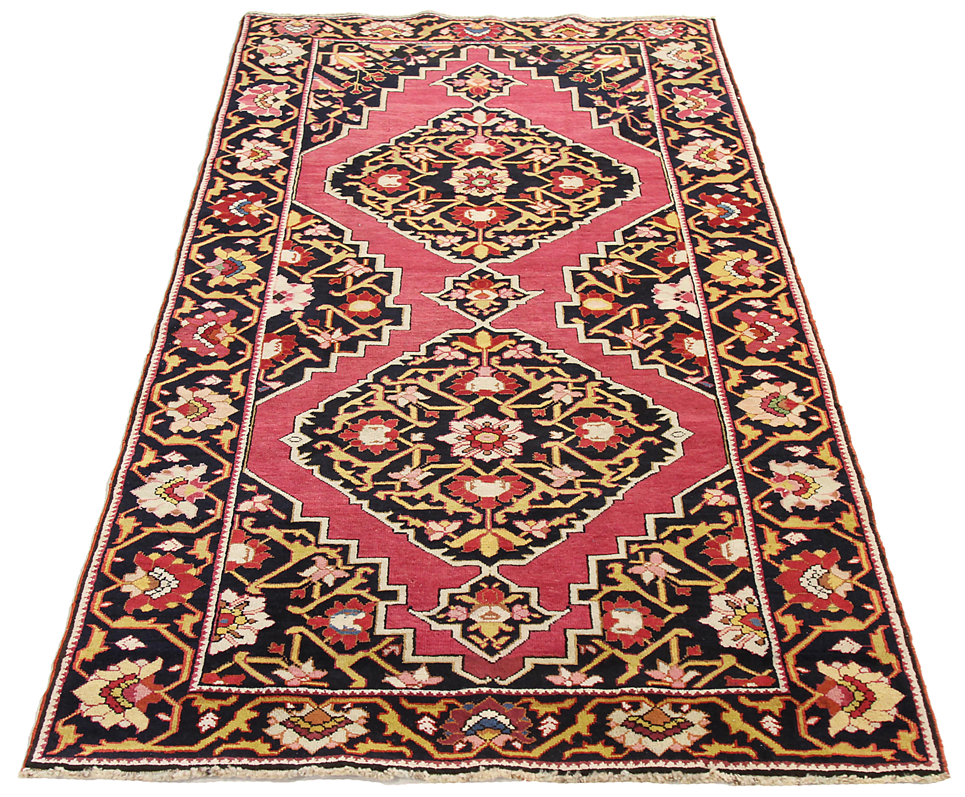 Antique Persian area rug handwoven from the finest sheep’s wool. It’s colored with all-natural vegetable dyes that are safe for humans and pets. It’s a traditional Azerbaijan design featuring floral patterns on a black field. It’s a lovely piece to
