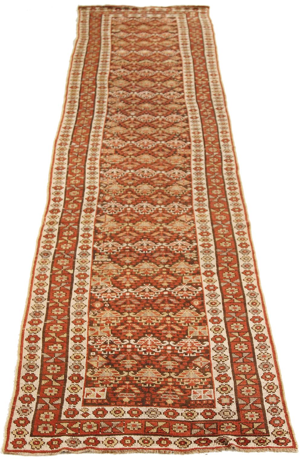 Antique Azerbaijan runner rug handwoven from the finest sheep’s wool and colored with all-natural vegetable dyes that are safe for humans and pets. It’s a traditional Azerbaijani design featuring mixed floral and botanical details over a deep red