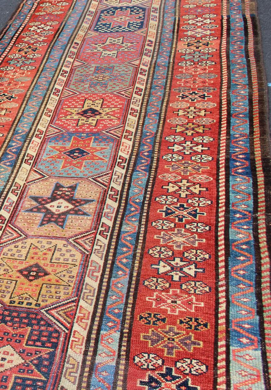 Hand-Knotted Antique Persian Kazak Runner with Medallions in Red, Blue, and Yellow For Sale