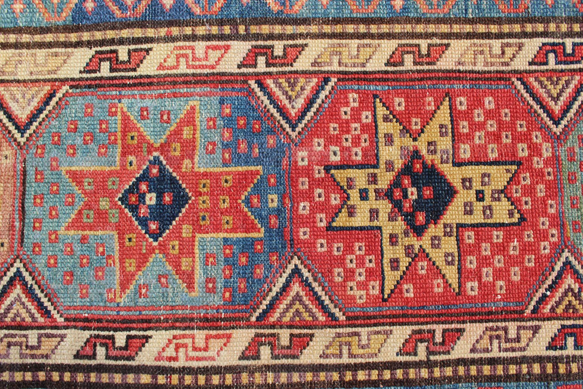 Early 20th Century Antique Persian Kazak Runner with Medallions in Red, Blue, and Yellow For Sale