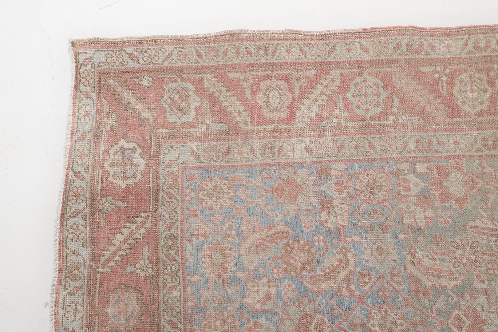 An enchanting Antique Persian Bakhsyayesh rug that features a myriad of botanical elements flourishing in the abrashed field in the most desirable warm tones. Enclosed floral meander inner and outer guard band, this rug displays an captivating
