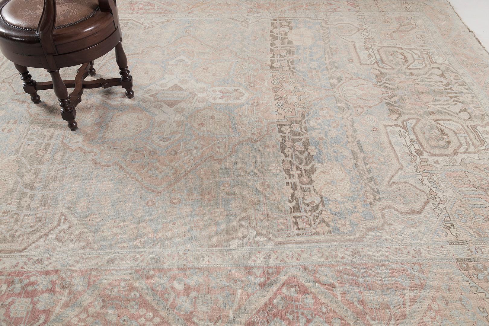 A magnificent antique Persian Bakhtiar rug with limitless forms that brings balance as each and every element cohesively unites with each other in a harmonious execution and composition. Featuring the majestic muted shades of dusty blue, tan, ecru,