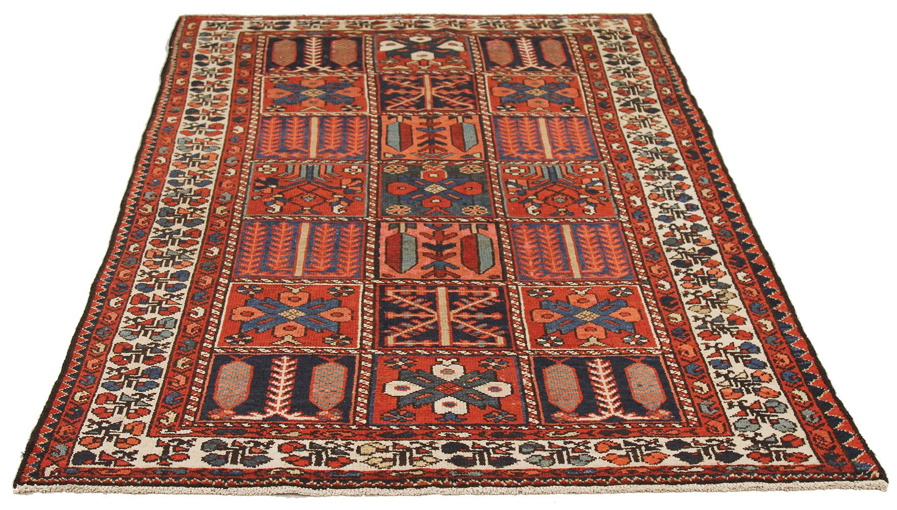 Antique Persian rug handwoven from the finest sheep’s wool and colored with all-natural vegetable dyes that are safe for humans and pets. It’s a traditional Bakhtiar design highlighted by blue and red tribal details over an ivory field. It’s a