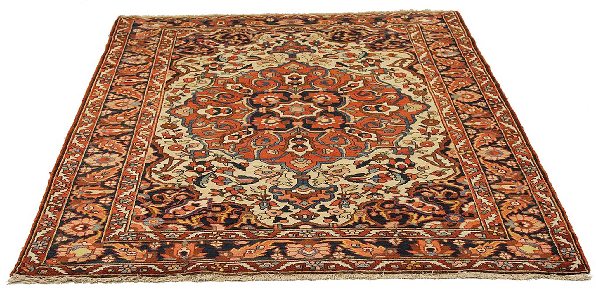 Antique Persian rug handwoven from the finest sheep’s wool and colored with all-natural vegetable dyes that are safe for humans and pets. It’s a traditional Bakhtiar design highlighted by an ivory field filled with floral details in brown, navy, and