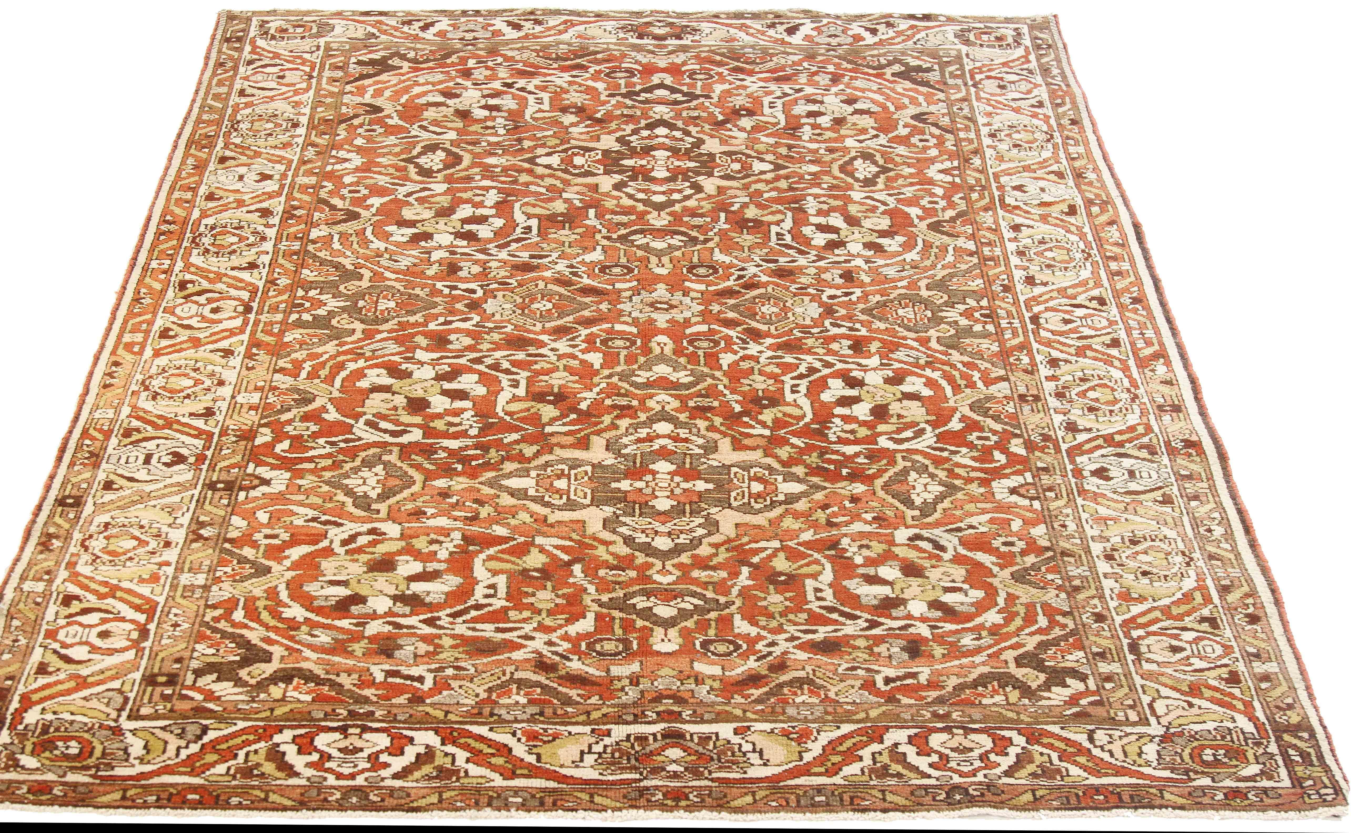 Antique Persian rug handwoven from the finest sheep’s wool and colored with all-natural vegetable dyes that are safe for humans and pets. It’s a traditional Bakhtiar design highlighted by a floral field in brown, red and ivory. It’s a beautiful