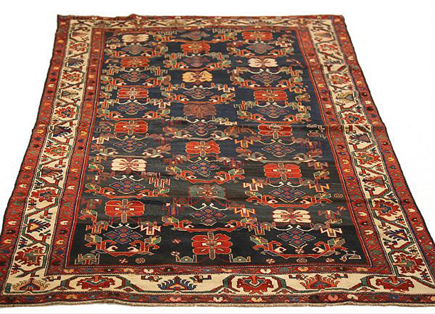 Antique Persian rug handwoven from the finest sheep’s wool and colored with all-natural vegetable dyes that are safe for humans and pets. It’s a traditional Bakhtiar design showing green and red flower patterns over a black field. It’s a beautiful