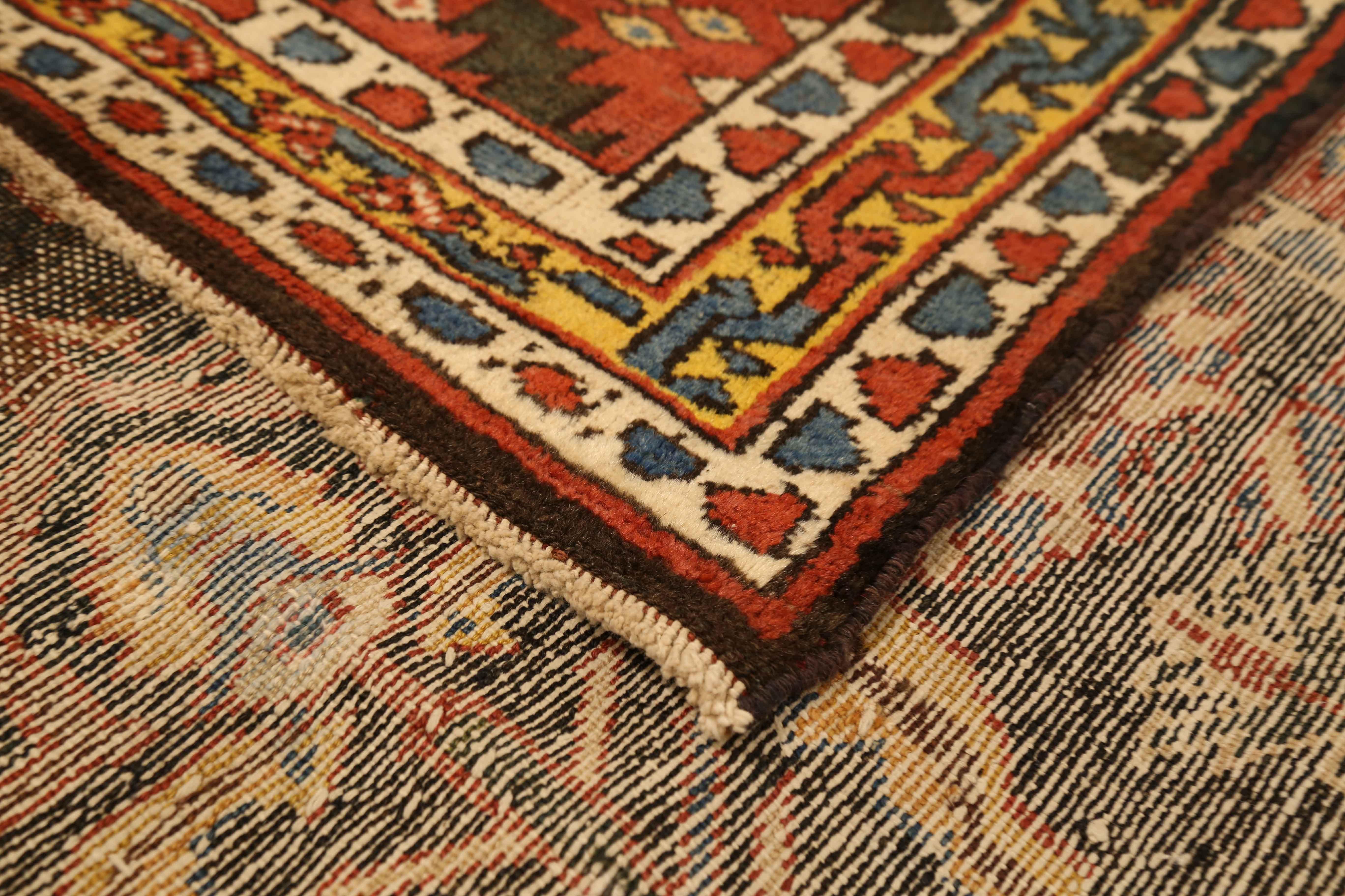 Antique Persian rug handwoven from the finest sheep’s wool and colored with all-natural vegetable dyes that are safe for humans and pets. It’s a traditional Bakhtiar design highlighted by diamond medallions in red, ivory, and blue over a black