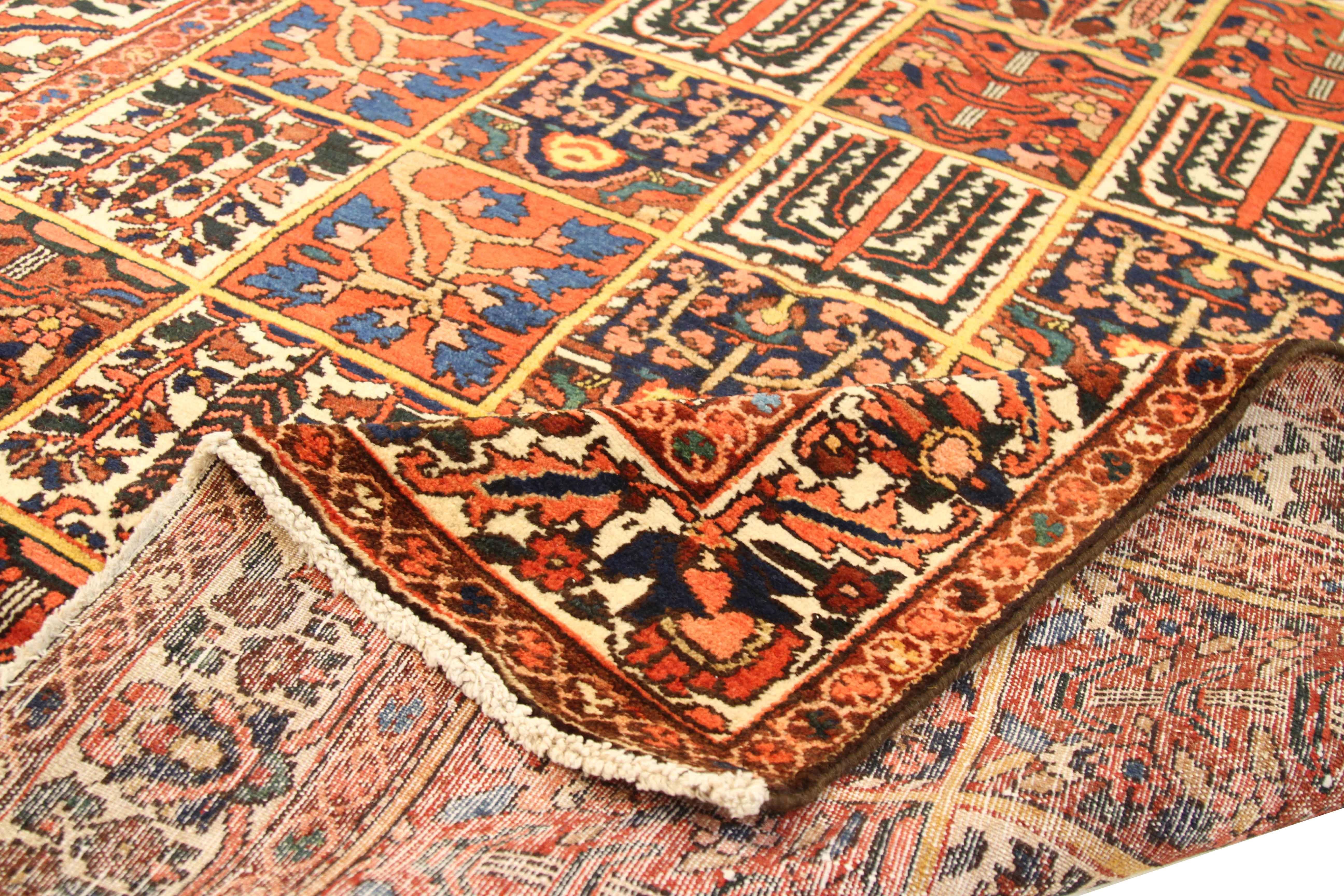 Antique Persian runner rug handwoven from the finest sheep’s wool and colored with all-natural vegetable dyes that are safe for humans and pets. It’s a traditional Bakhtiar design featuring floral tiles in red, white, and blue over a red center