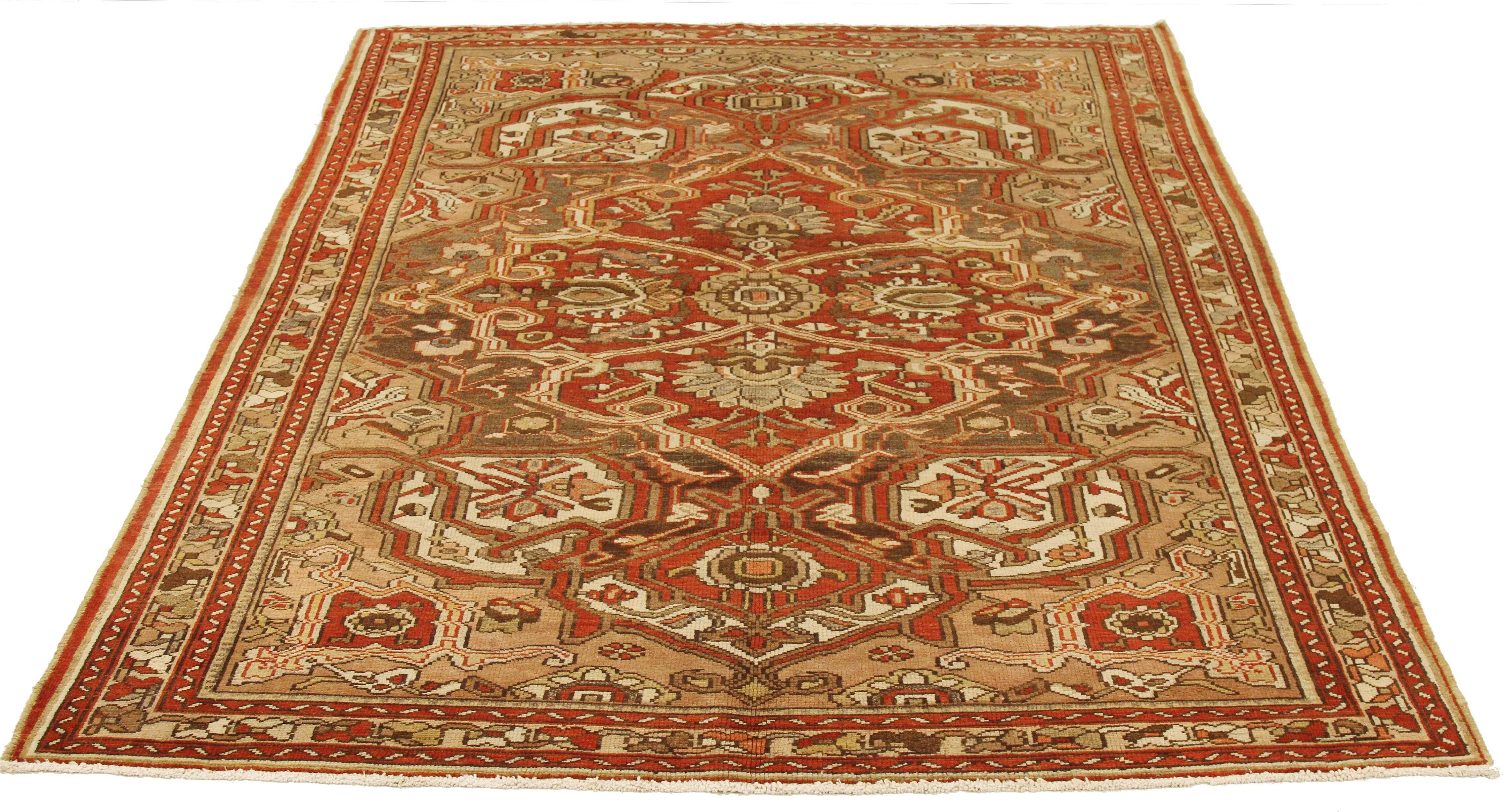 Antique Persian rug handwoven from the finest sheep’s wool and colored with all-natural vegetable dyes that are safe for humans and pets. It’s a traditional Bakhtiar design highlighted by a large floral medallion in red and brown on an ivory field.