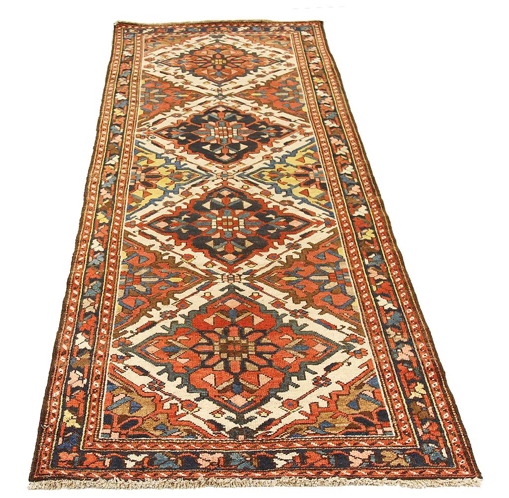 Antique Persian rug handwoven from the finest sheep’s wool and colored with all-natural vegetable dyes that are safe for humans and pets. It’s a traditional Bakhtiar design highlighted by navy and red diamonds over an ivory field. It’s a beautiful