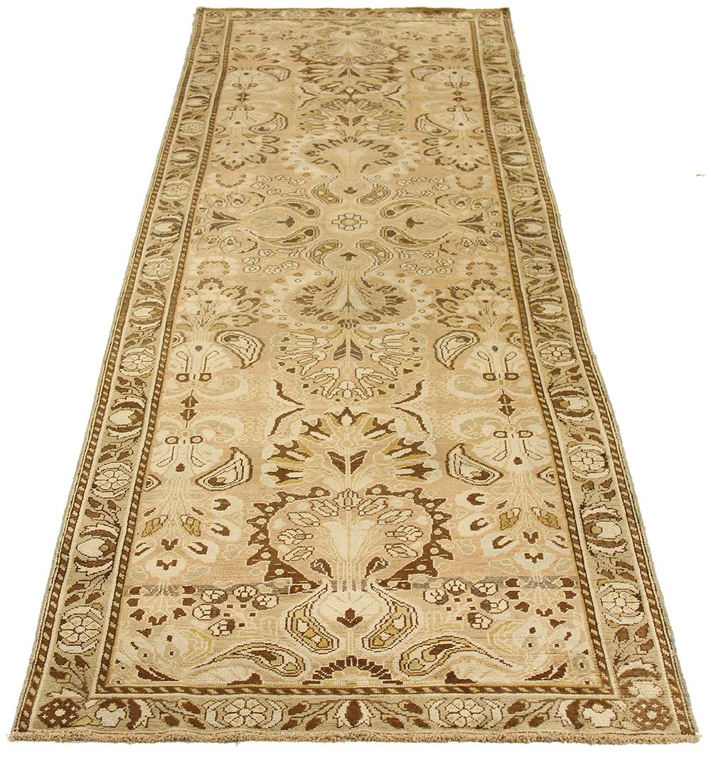 Antique Persian rug handwoven from the finest sheep’s wool and colored with all-natural vegetable dyes that are safe for humans and pets. It’s a traditional Bakhtiar design highlighted by brown and ivory botanical details over a beige field. It’s a