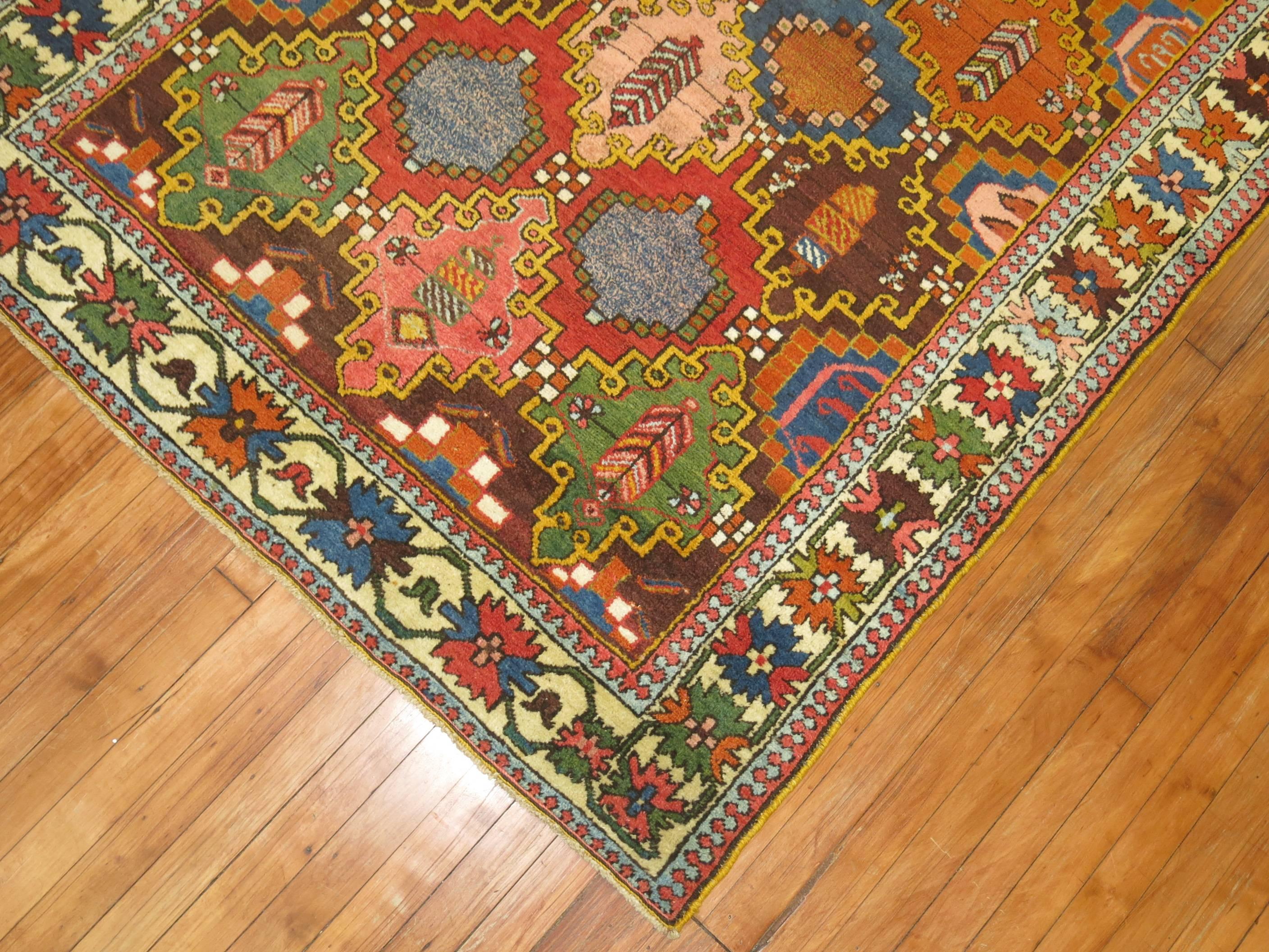 An early 20th century colorful Persian Bakhtiari rug featuring colorful accents predominantly in blue, green and pink.