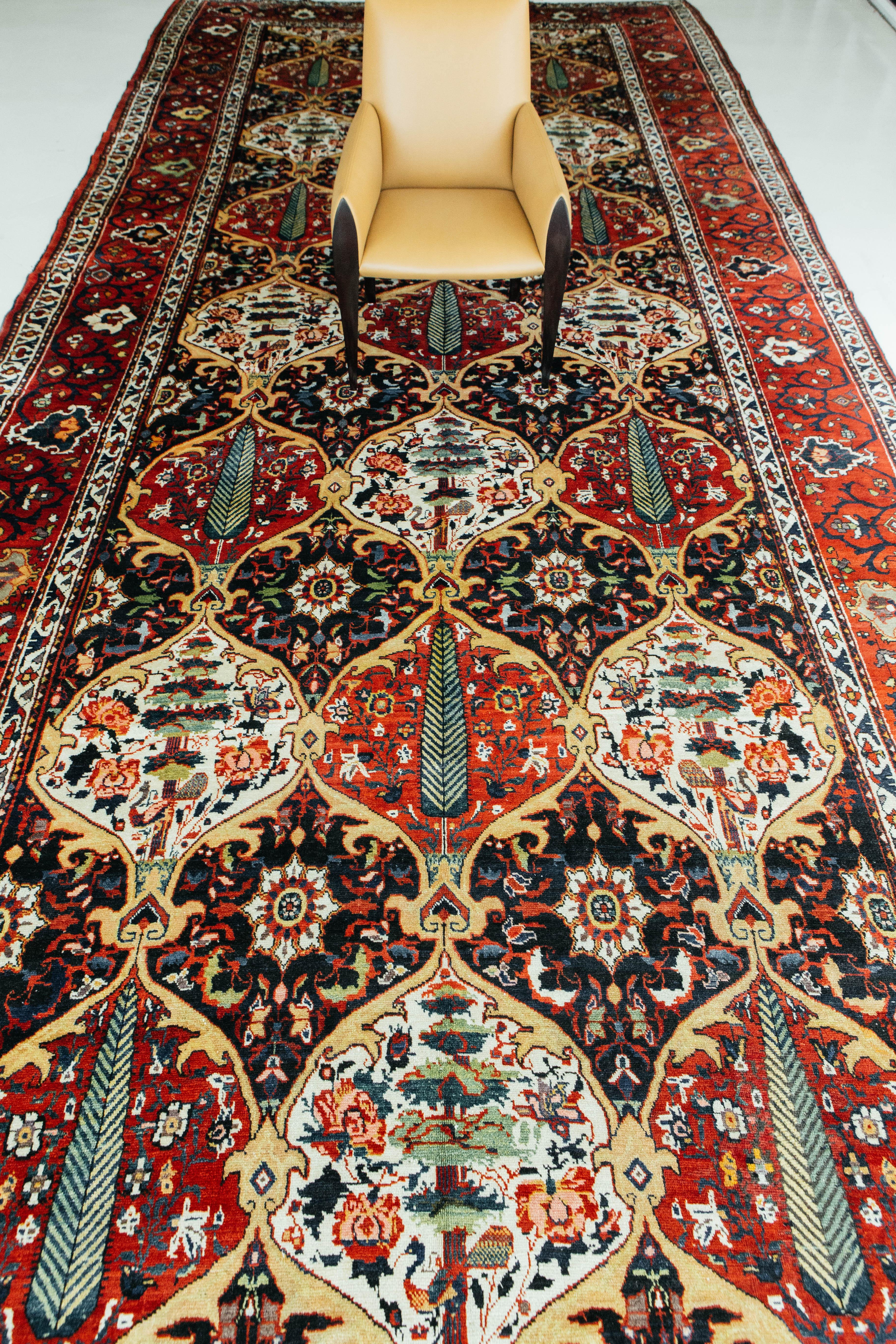 The antique Persian Bahktiari rug is handmade and features an array of colors. The large size of this piece makes it ideal for flooring applications. Add this fine piece of art to your home and collection now. Visit our showroom in Los Angeles, in