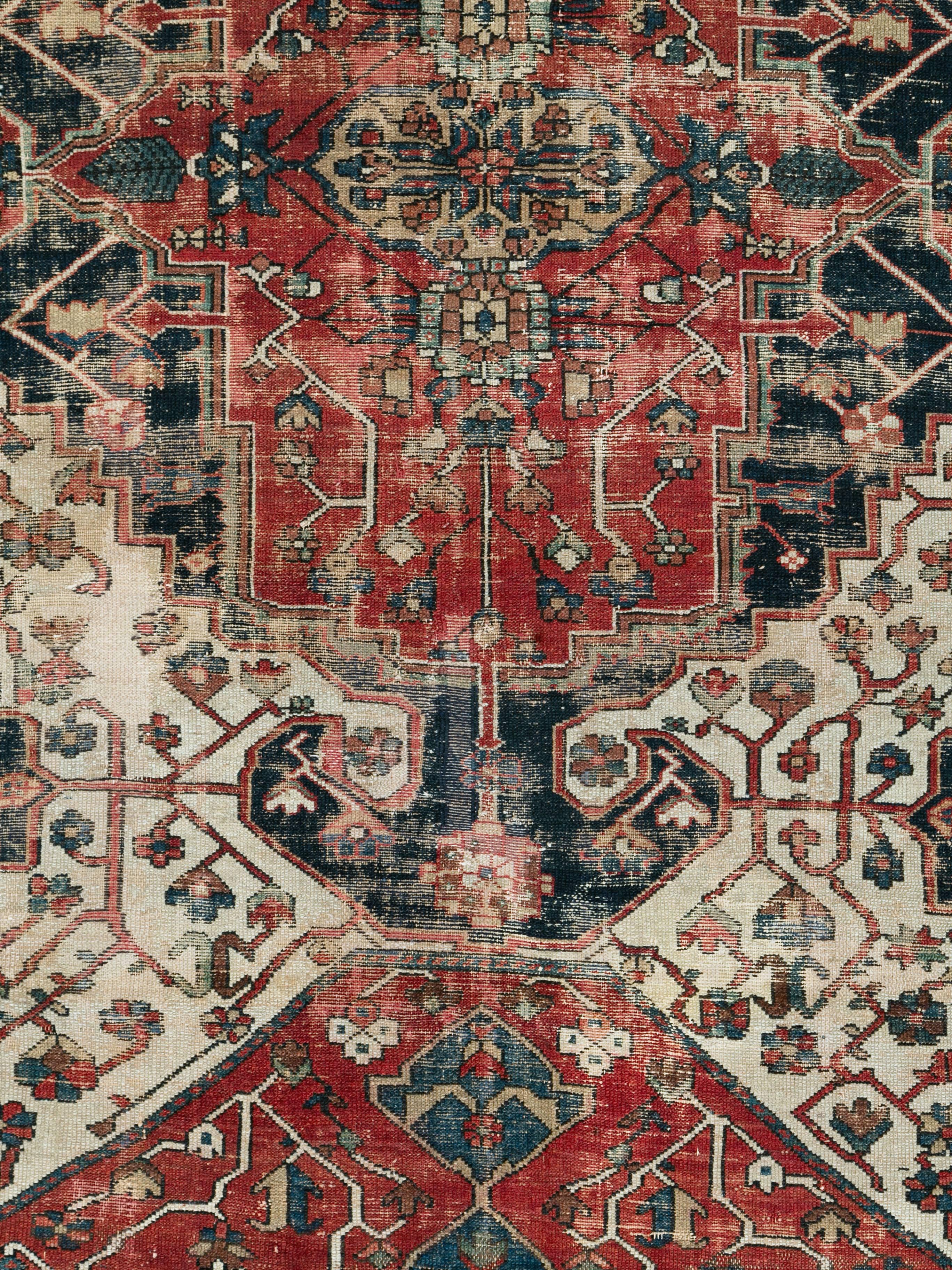 An antique Persian Bakhtiari rug from the early 20th century with a naturally distressed appeal.