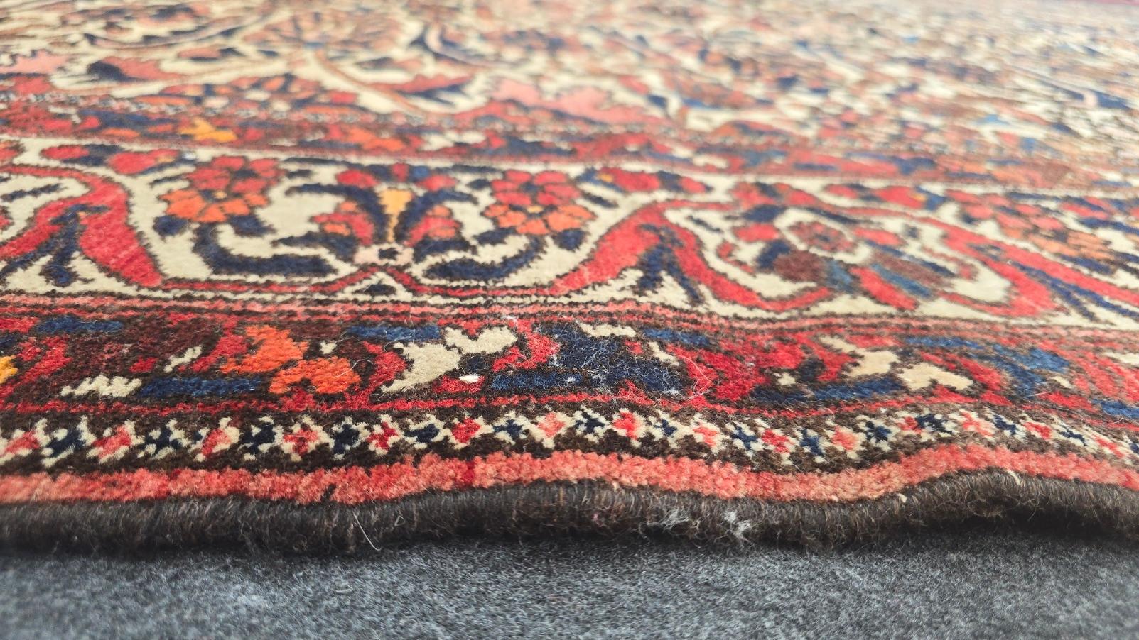 Step into the rich history of Persian craftsmanship with this exquisite Early 20th Century Bakhtiari Rug, a captivating handwoven piece measuring 7.3 x 10.1 feet. Known for their bold designs and intricate detailing, Bakhtiari rugs reflect the