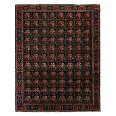 Tapis persan Bakhtiari ancien avec des fleurs noires, rouges et bleues