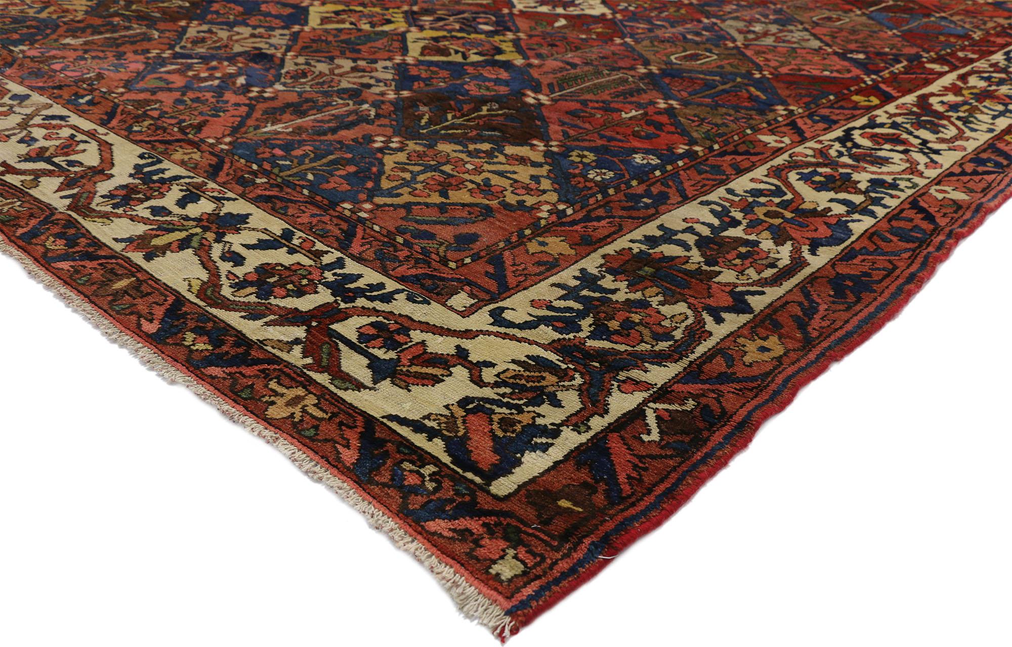 Rich jewel tones integrated with a rich patina, this antique Persian Bakhtiari rug features a garden design and traditional modern style. Classically composed and boasting a truly magnificent panel compartment garden design, this antique Bakhtiari