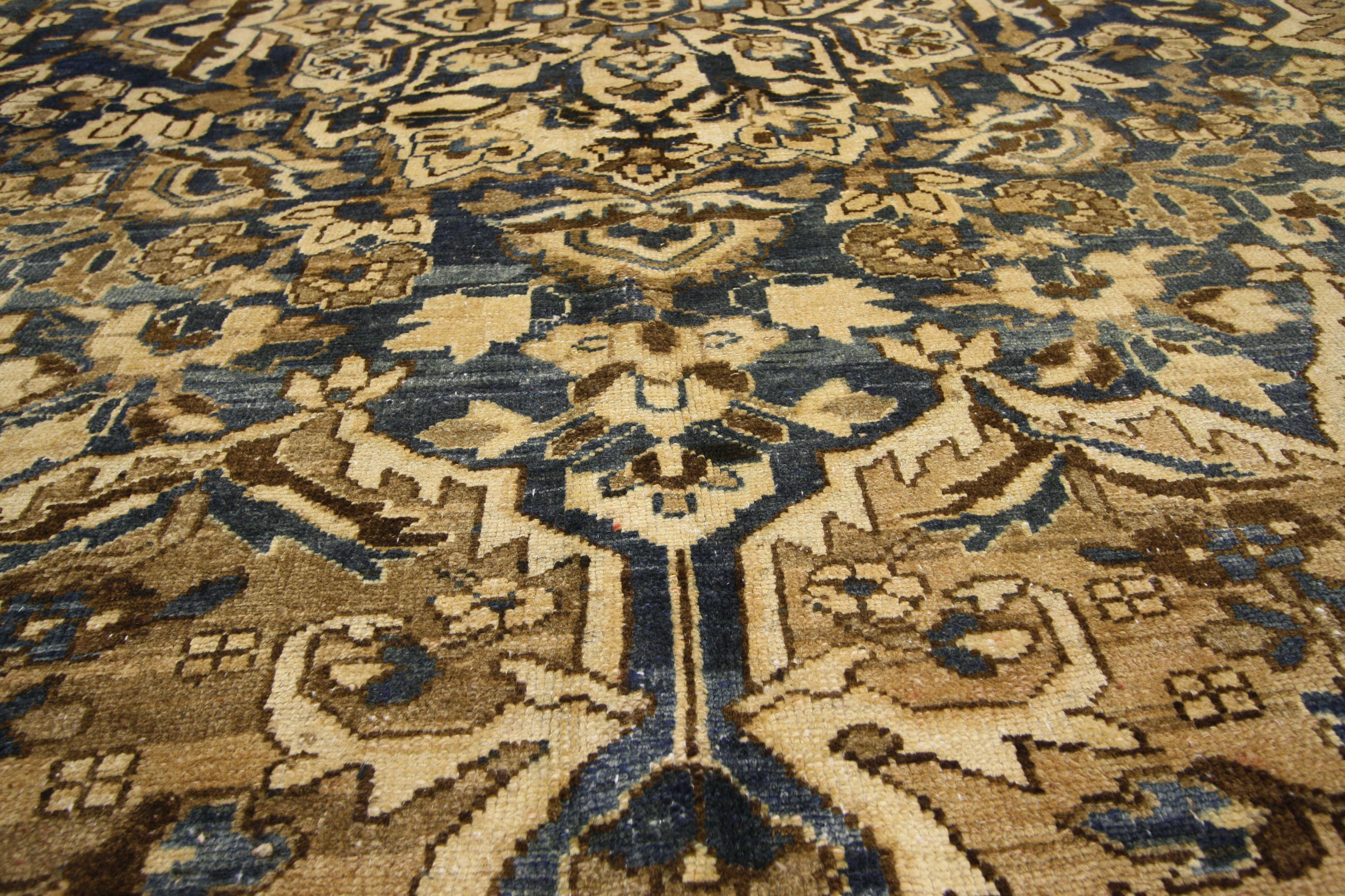 Antique Persian Bakhtiari rug with in traditional modern style. This hand-knotted wool antique Persian Bakhtiari rug features a traditional style. A grandeur 16-point central medallion is covered in a lattice of vines blooming with lotus and