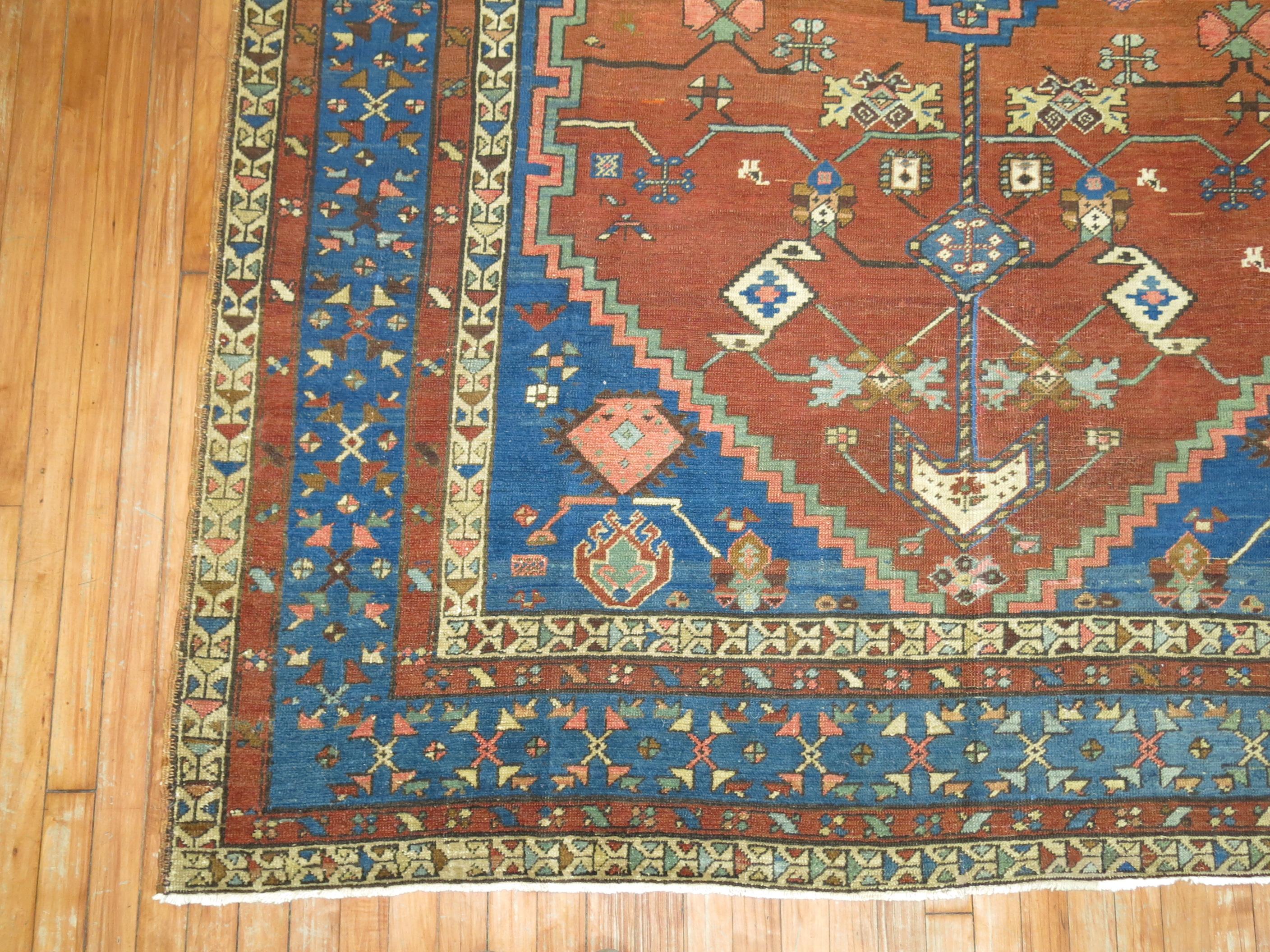 A rare size early 20th century Persian Bakshaish Rug.

Bakshaish weavers employed both soft orange and soft blue accents for the base color of the field, with the use of ivory or camelhair grouns being particularly rare and beloved. Exceptional