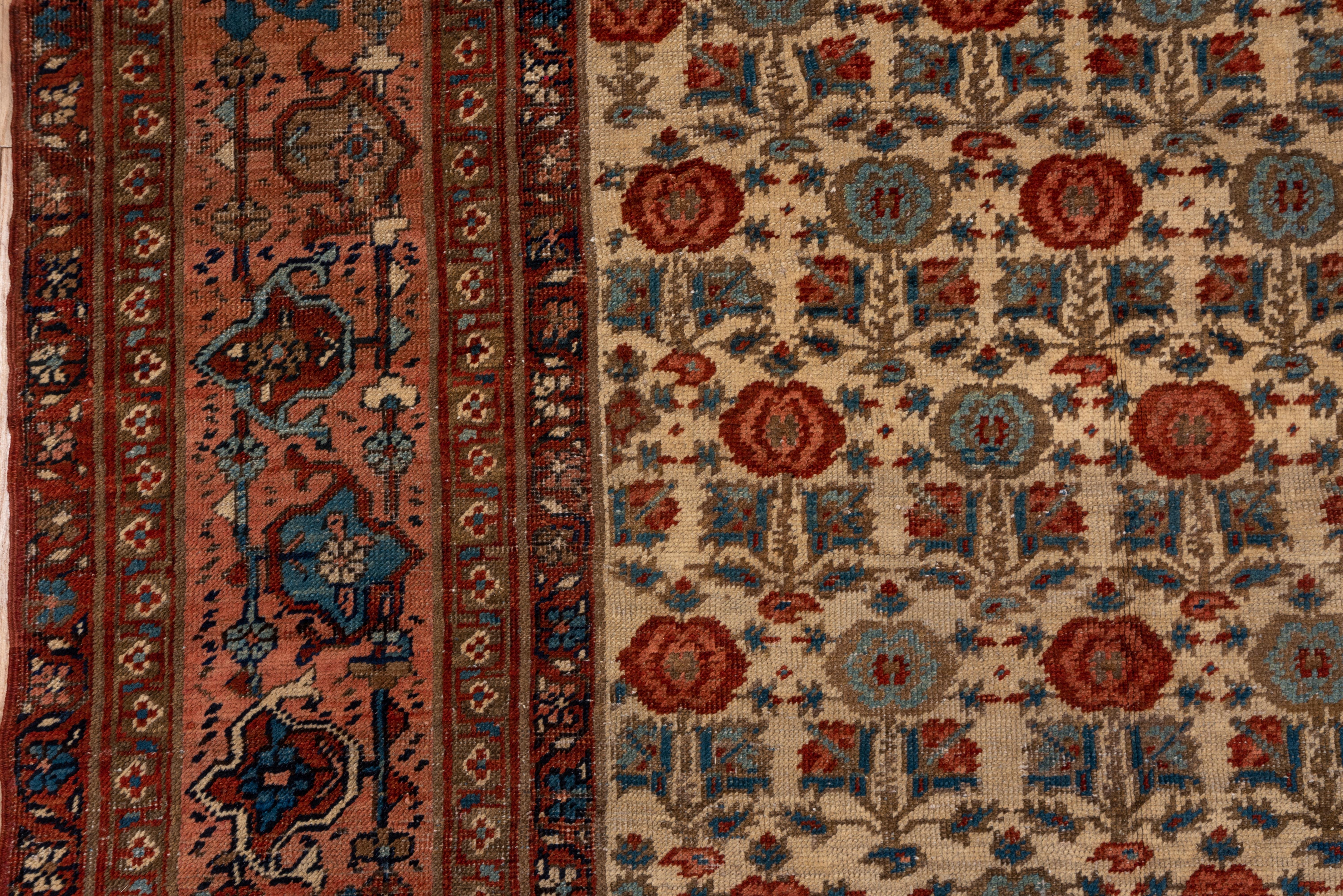 The old ivory field displays offset rows of flowers, all closely adopted from 18th century Persian silk textiles, and a shrimp main border of wonky reversing escutcheon palmettes. Red, teal and green details.