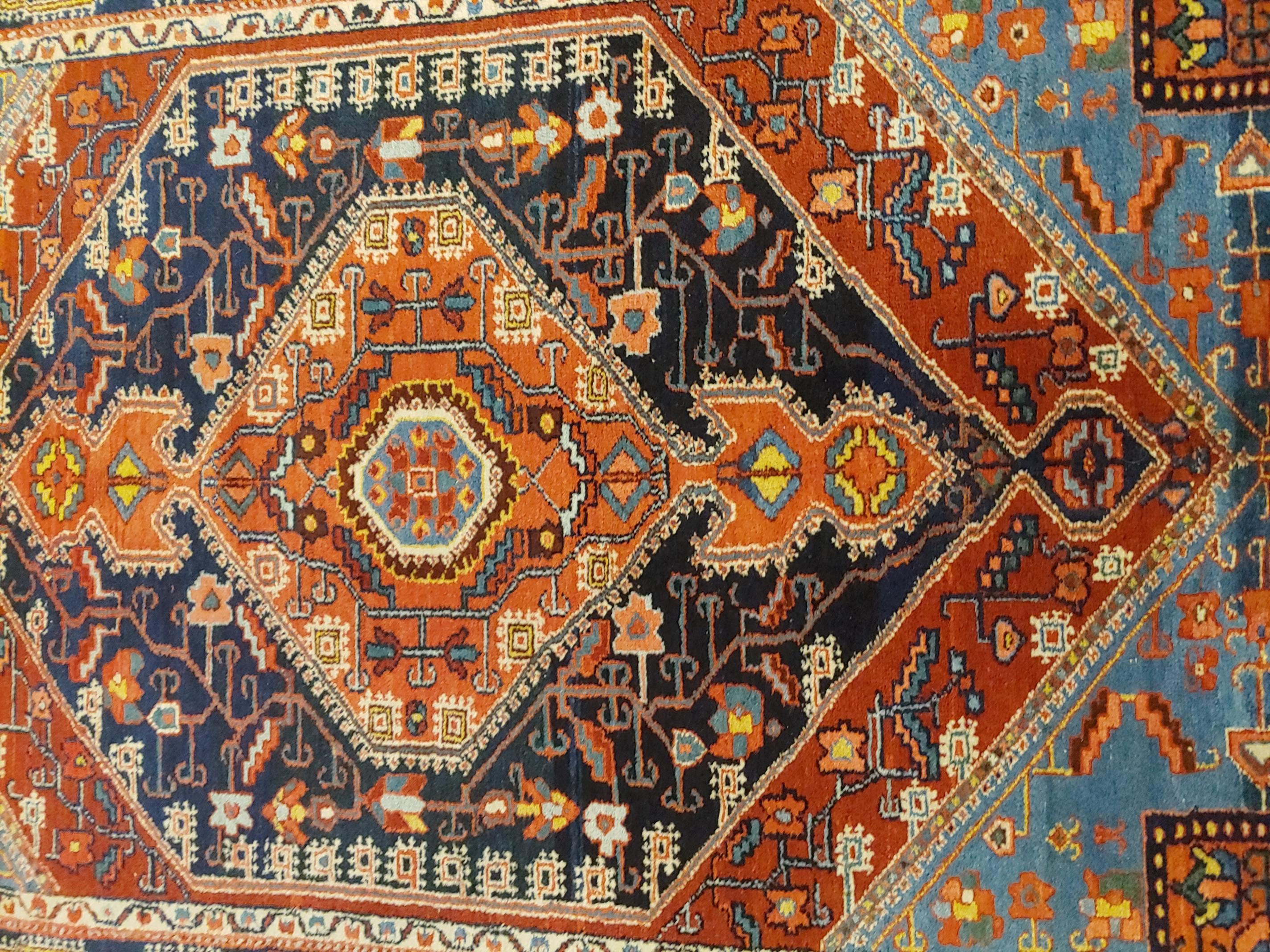A very beautiful geometric design Persian Baktiari from around 1920. Striking colors of light and dark blue, rust, and salmon. Looks similar to an antique Heriz or Serapi but cost a lot less. Measures: 4-6 x 6-5.
