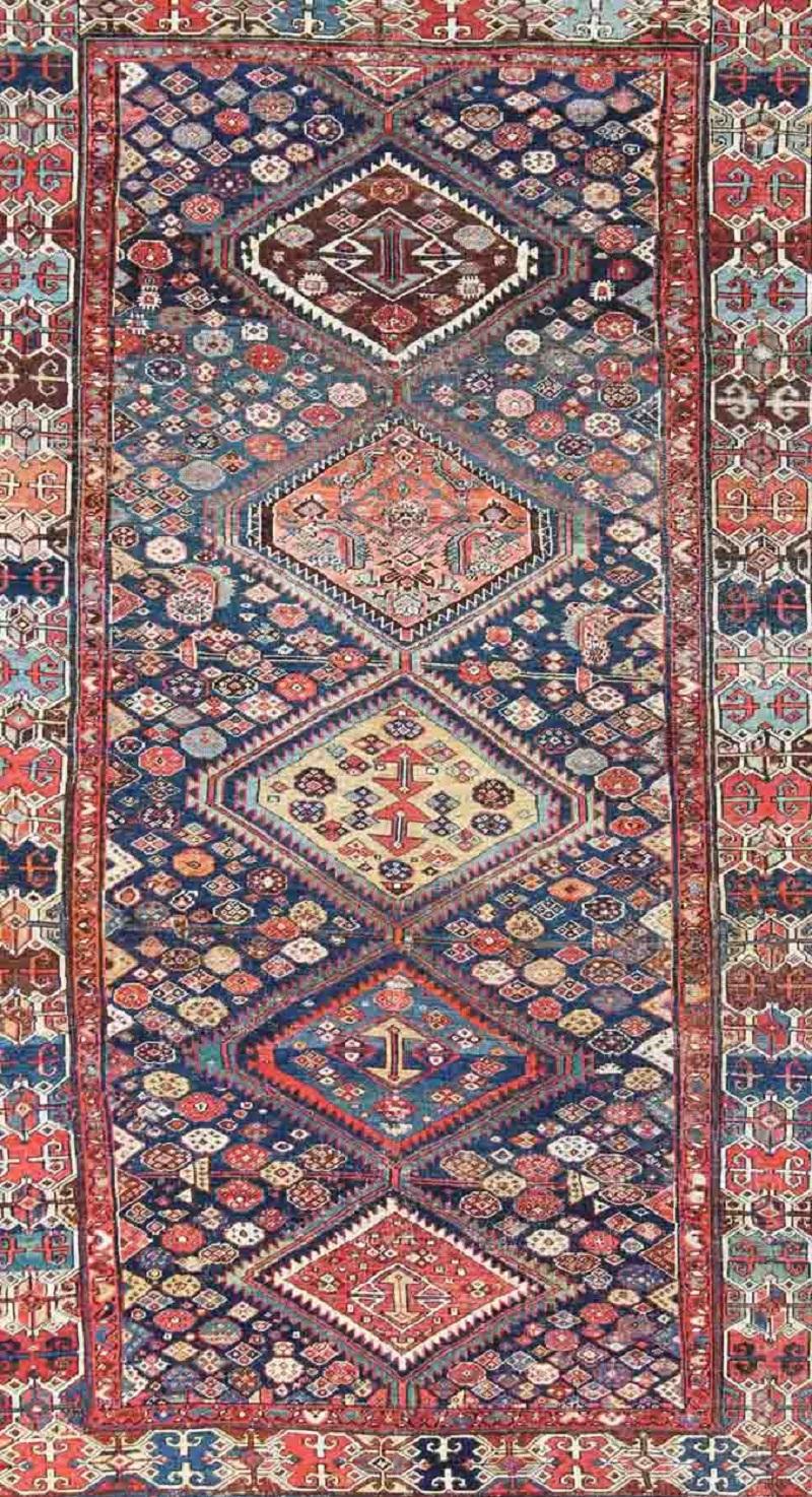Tribal Antique Persian Bibikabad Rug with Diamond Medallions in Blue Background For Sale