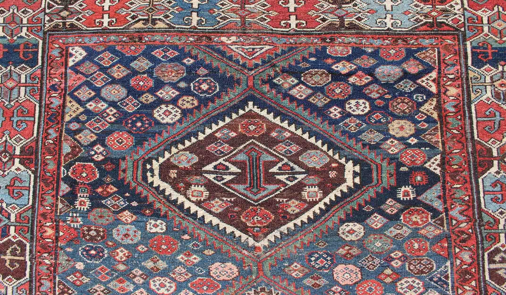Wool Antique Persian Bibikabad Rug with Diamond Medallions in Blue Background For Sale