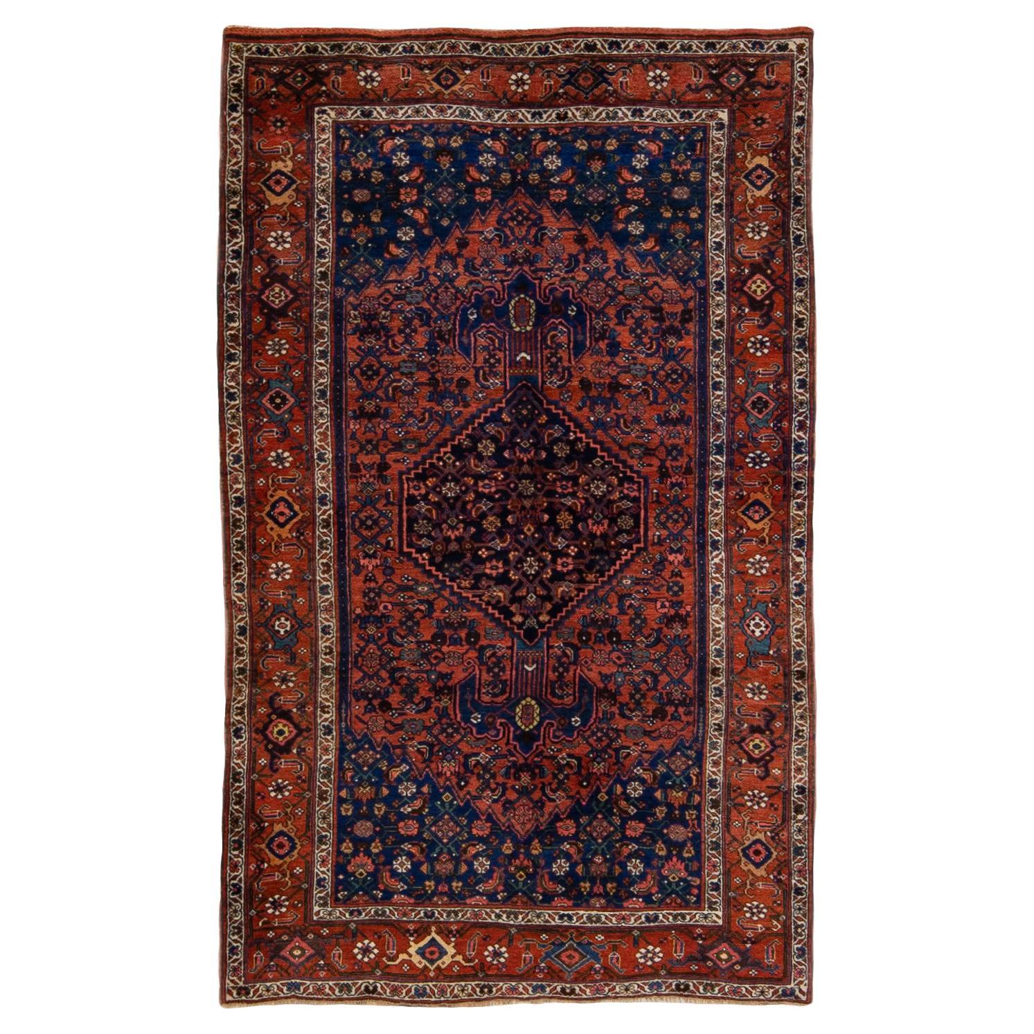 Tapis persan ancien Bidjar en laine médaillon bleu et rouille fait à la main