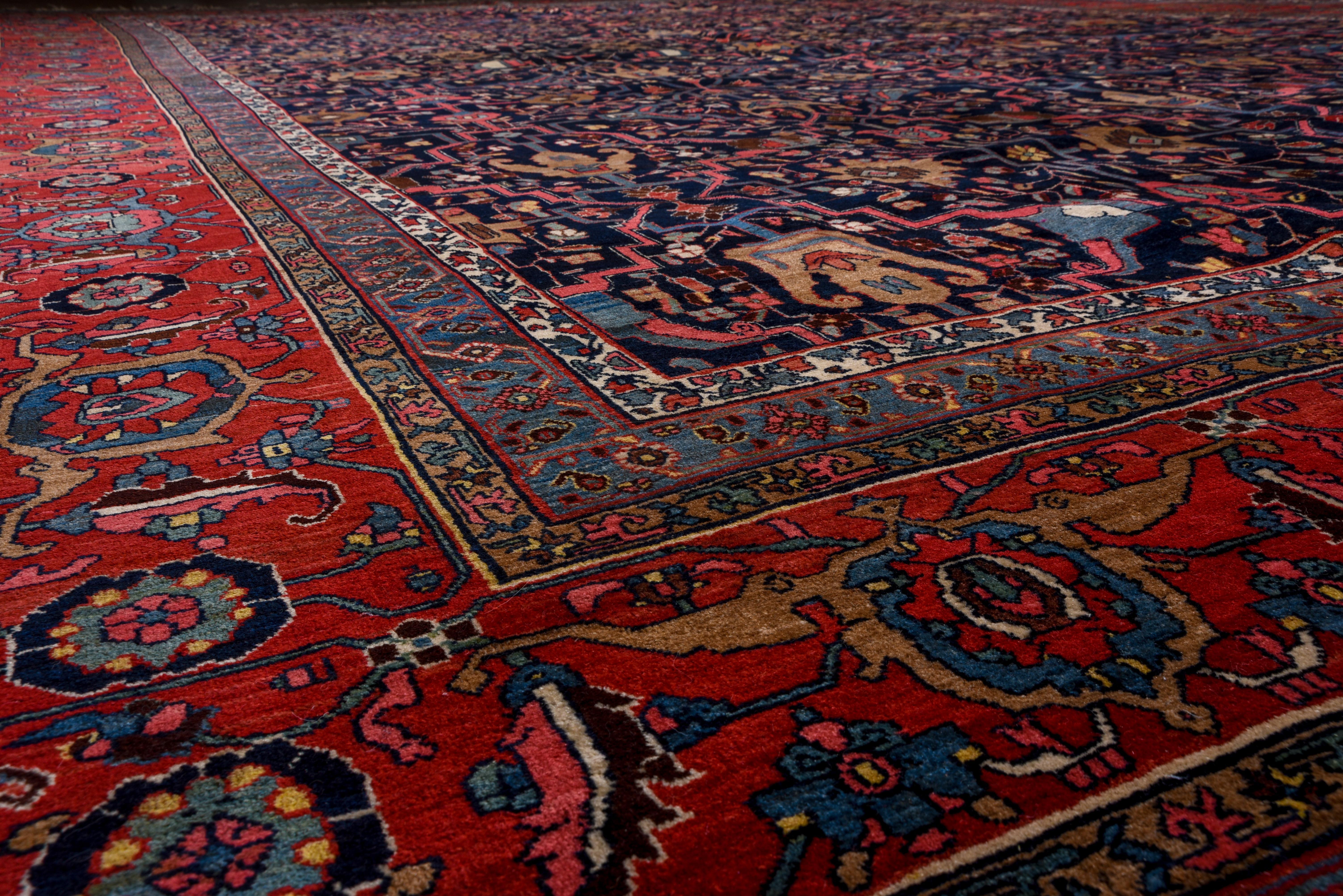 The rich navy indigo field of this carpet is rigorously organized by a strap work delineating cartouches and stiff connecting bars with palmette and split arabesque decoration. The madder red border features reversing turtle palmettes. Excellent