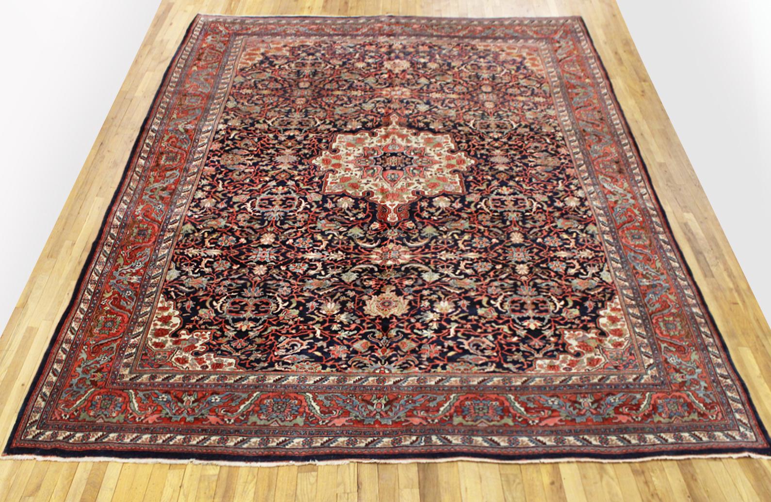 Antique Persian Bidjar rug, in room size, circa 1920.

A one-of-a-kind antique Persian Bidjar rug, hand-knotted with soft wool pile. Thiis lovely hand-knotted woll rug features a central medallion in the navy central field, with a delicate red