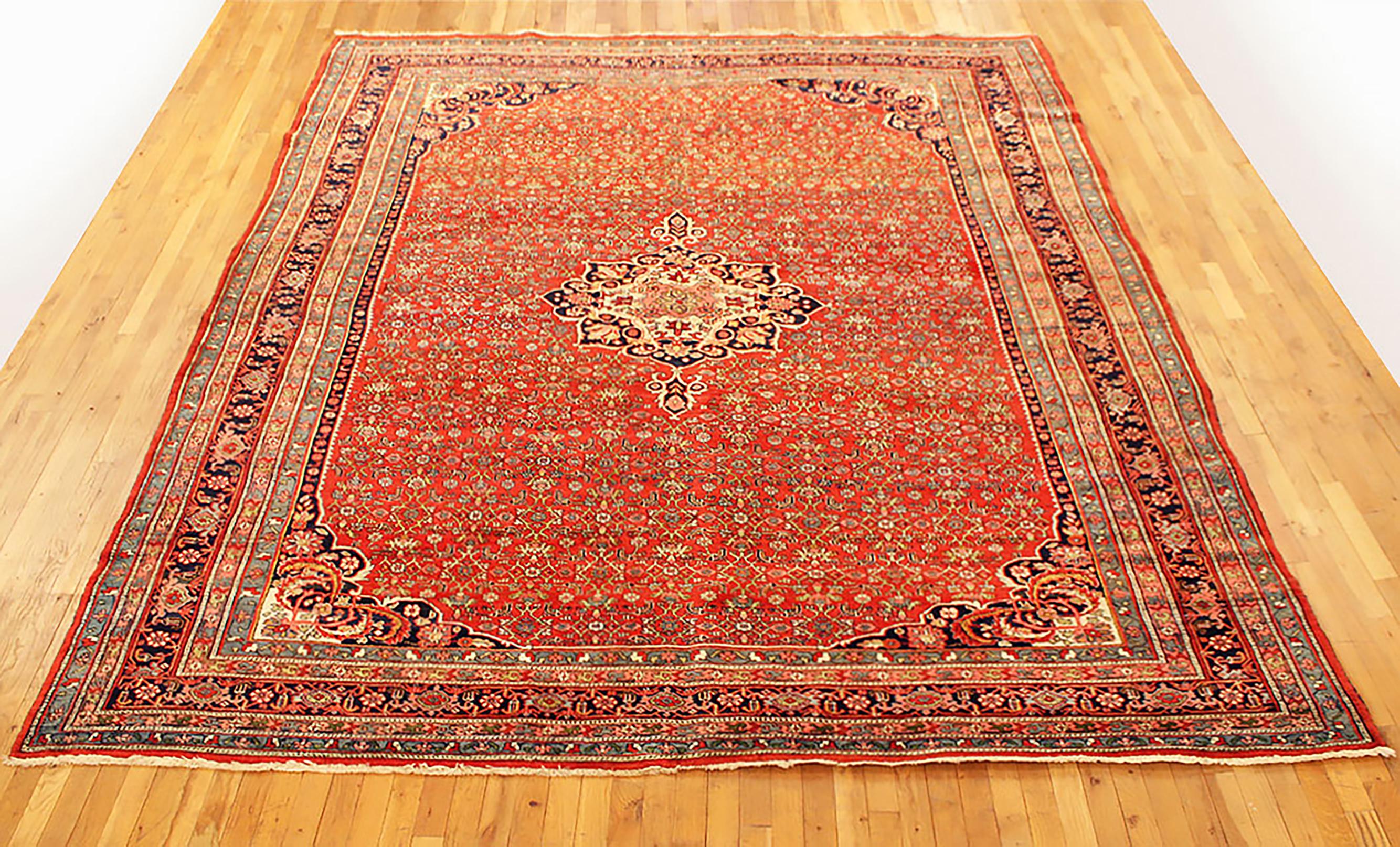 Antique Persian Bidjar Rug, Room size, circa 1900

A one-of-a-kind antique Persian Bidjar Oriental Carpet, hand-knotted with soft wool pile. This beautiful rug features a central medallion with a repeating design, on the red primary field, with a
