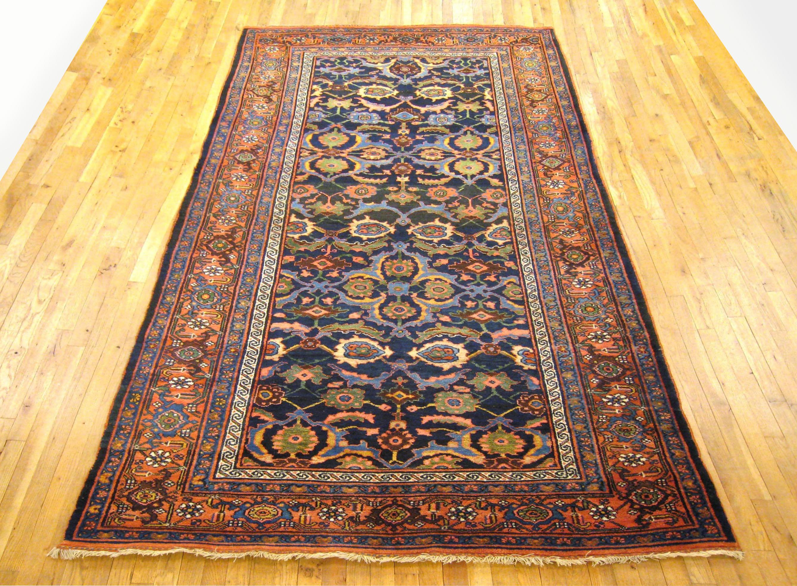 Antique Persian Bidjar Rug, Runner size, circa 1900.

A one-of-a-kind antique Persian Bidjar Oriental Carpet, hand-knotted with soft wool pile. This beautiful rug features floral elements allover the navy primary field, with a red outer border. In