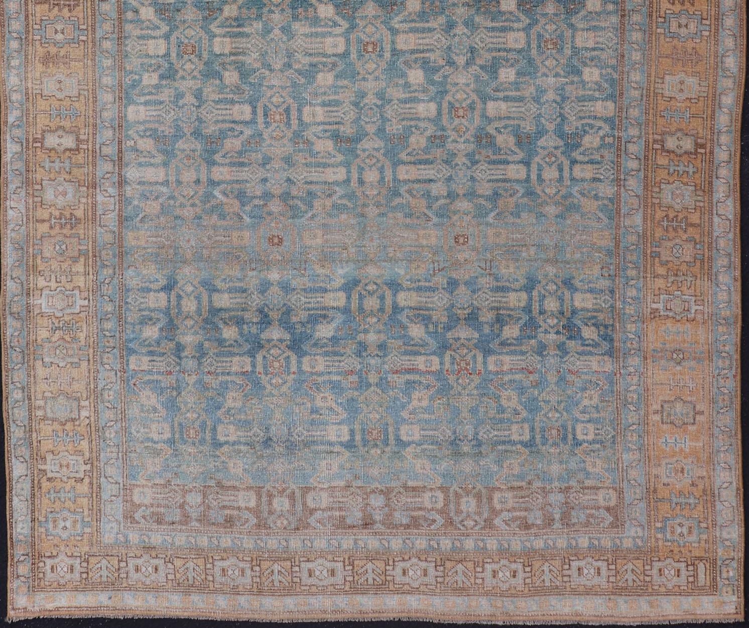 Antique Persian rug in light blue, cream, orange, brown and neutral tones with geometric motifs, Keivan Woven Arts / rug EMB-9565-P13858, country of origin / type: Iran / Bijar, circa 1910.

This Persian Bidjar carpet from 1910 is characterized by