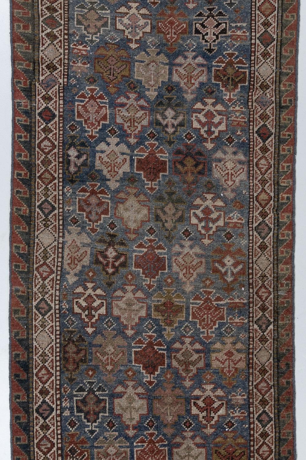 Age: late 20th century

Pile: Low

Wear Notes: 1-2

Material: Wool on wool

Excellent condition antique Persian runner with a blue field and geometric floral motif.

Vintage rugs are made by hand over the course of months, sometimes years.