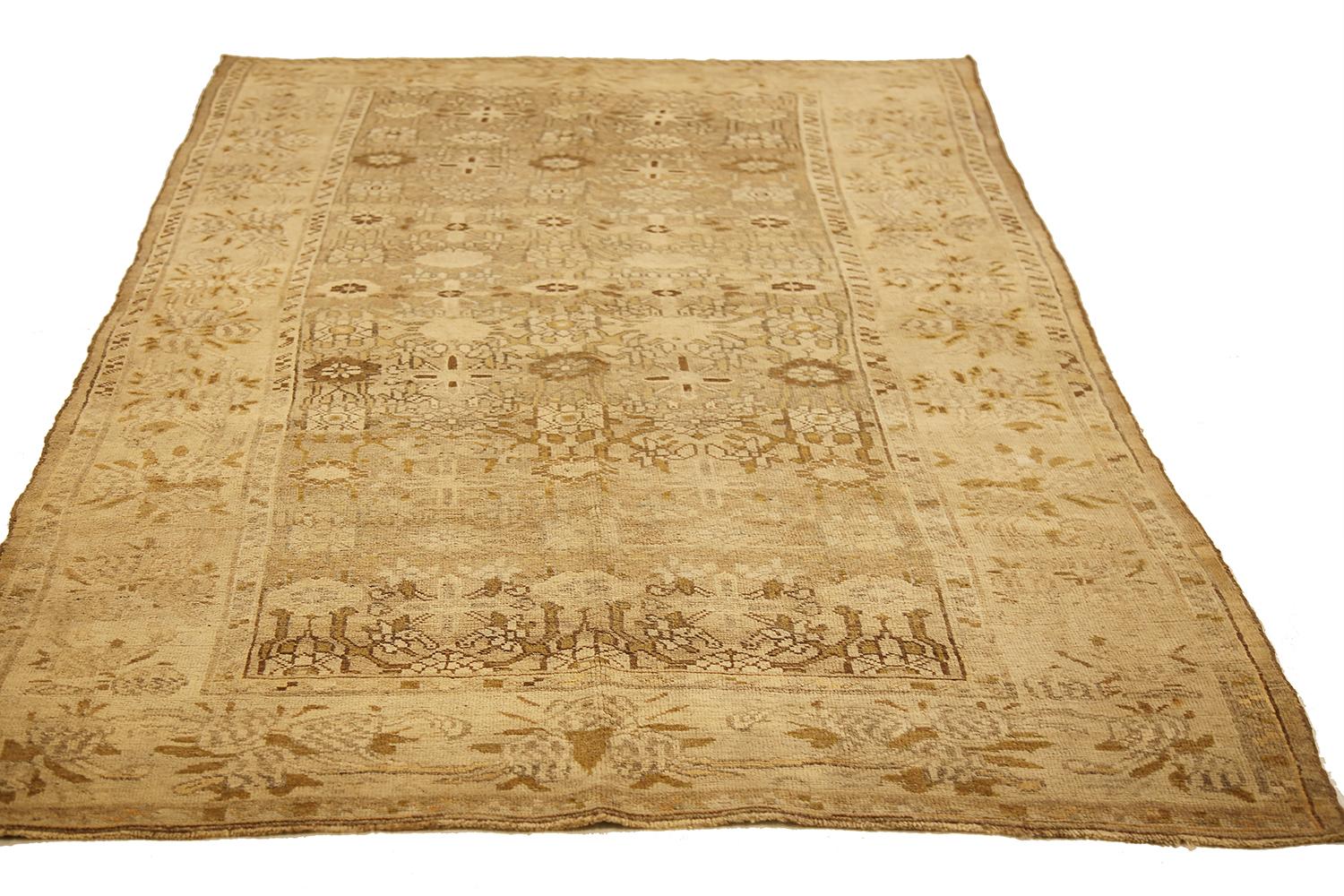 Antique Persian rug handwoven from the finest sheep’s wool and colored with all-natural vegetable dyes that are safe for humans and pets. It’s a traditional Bijar design featuring lovely brown and beige floral details. It has all-over rows of floral