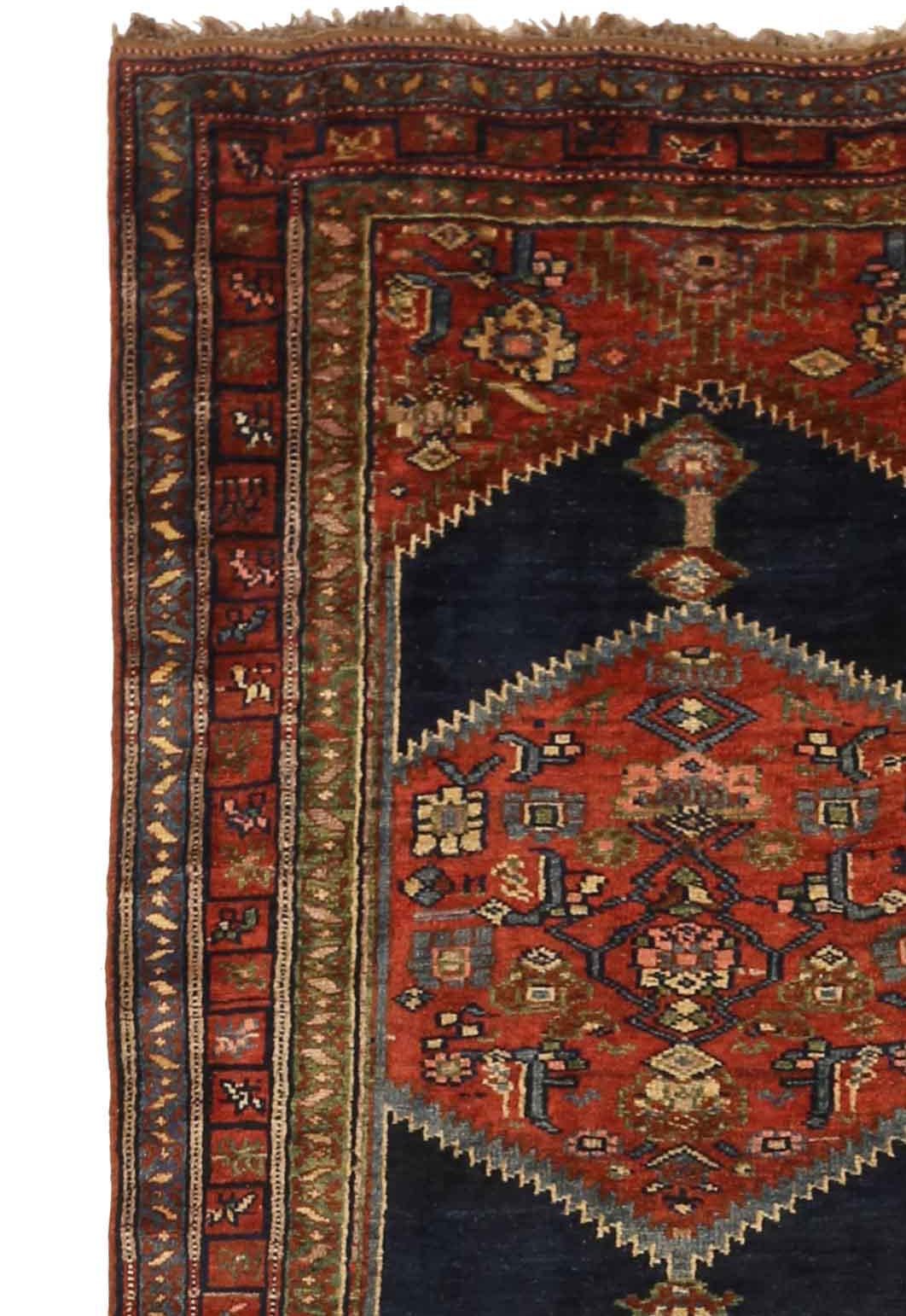 Antique Persian rug handwoven from the finest sheep’s wool and colored with all-natural vegetable dyes that are safe for humans and pets. It’s a traditional Bijar design featuring floral medallion details inside large arrowheads in navy blue over a