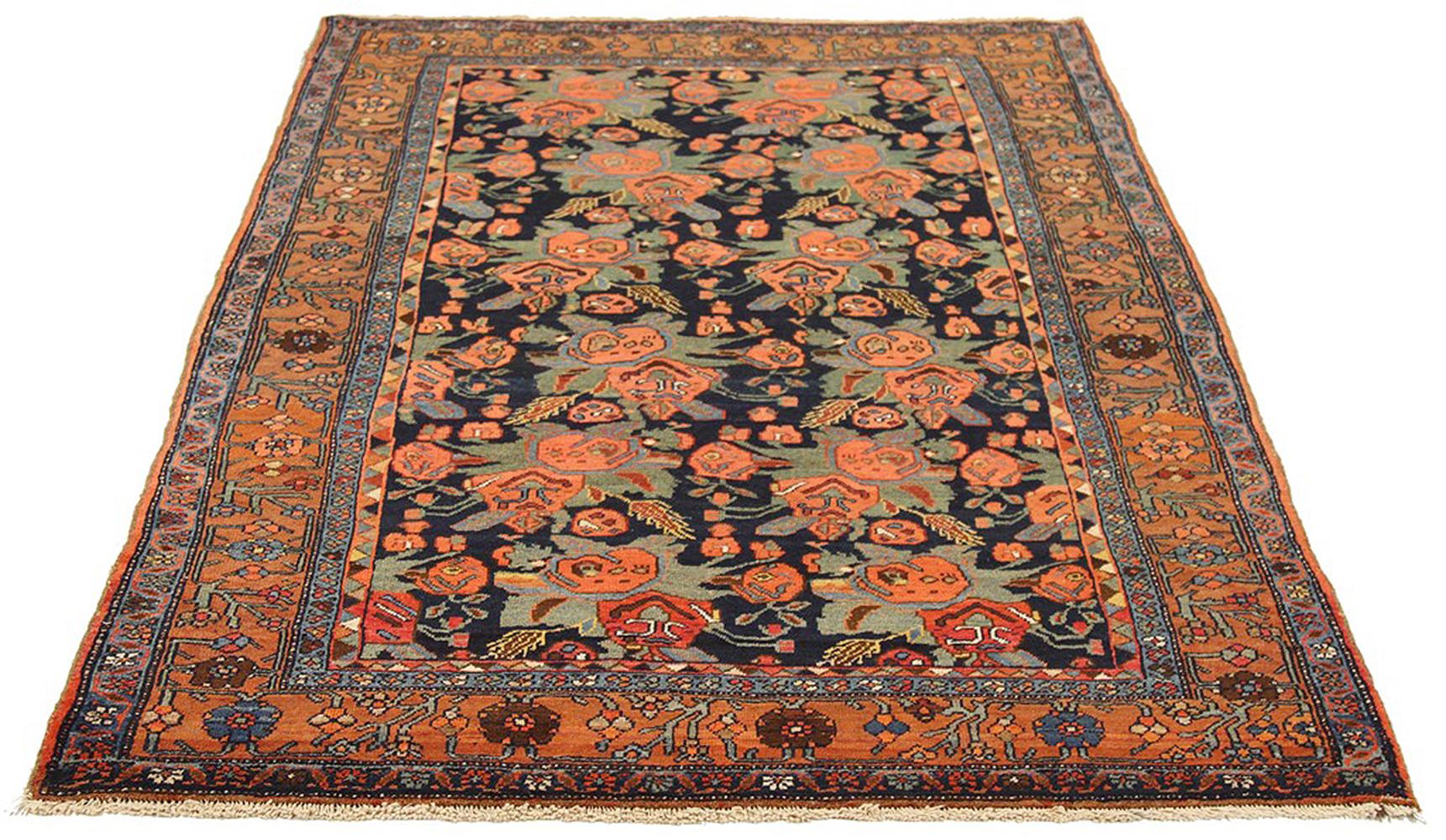 Antique Persian rug handwoven from the finest sheep’s wool and colored with all-natural vegetable dyes that are safe for humans and pets. It’s a traditional Bijar design featuring floral details in pink and green over a black field. It’s a stunning