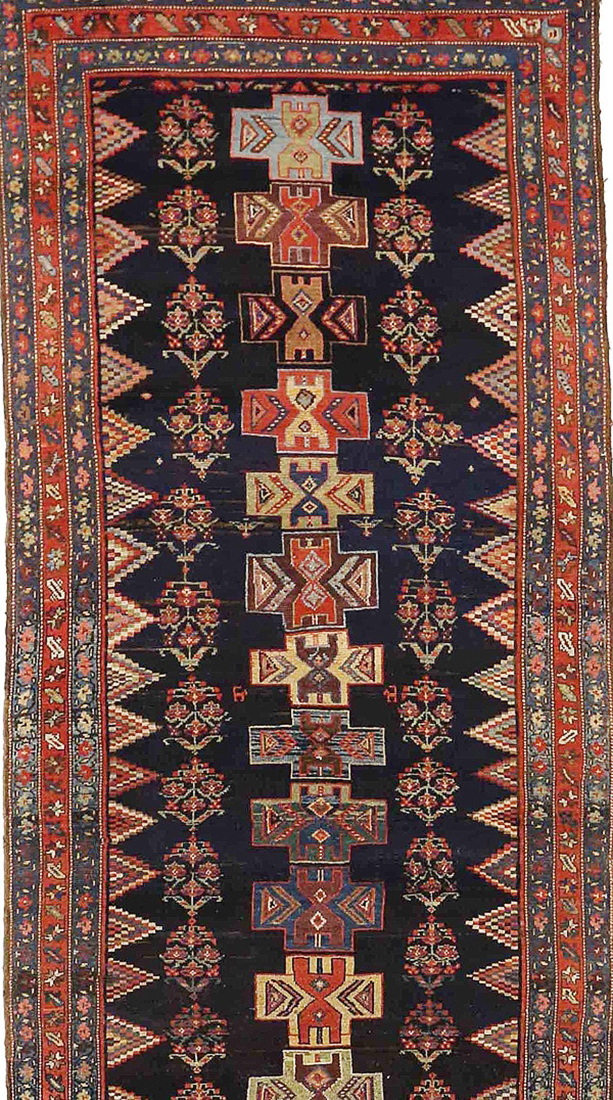 Antique Persian runner rug handwoven from the finest sheep’s wool and colored with all-natural vegetable dyes that are safe for humans and pets. It’s a traditional Bijar design featuring multicolored flower and cross medallion details over a navy