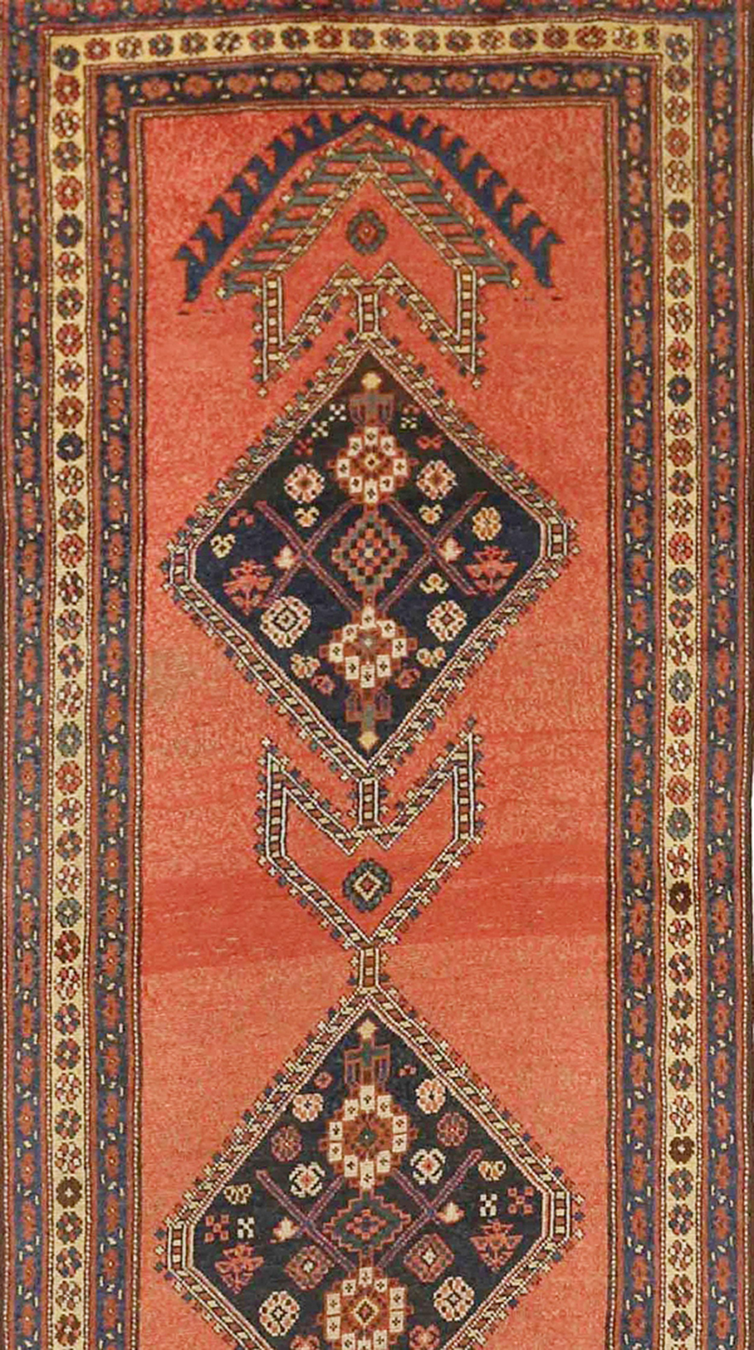 Antique Persian runner rug handwoven from the finest sheep’s wool and colored with all-natural vegetable dyes that are safe for humans and pets. It’s a traditional Bijar design featuring multicolored diamond medallions filled with floral details