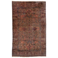 Antiker persischer blauer und rosafarbener, geblümter Kirman-Teppich