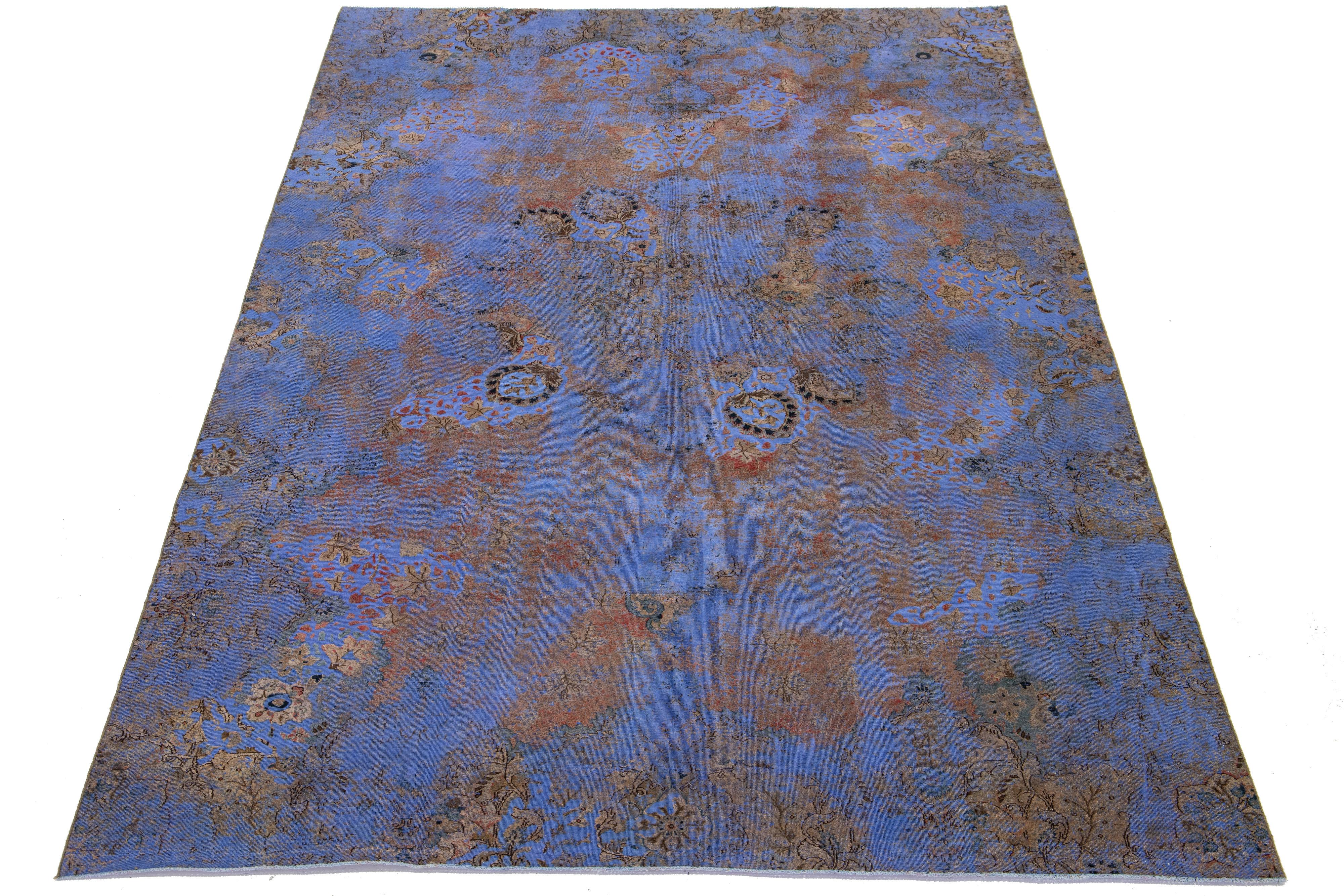 This antique blue Persian wool rug features a floral design with beige, rust, and brown accents.

This rug measures 7'5'' x 12'5