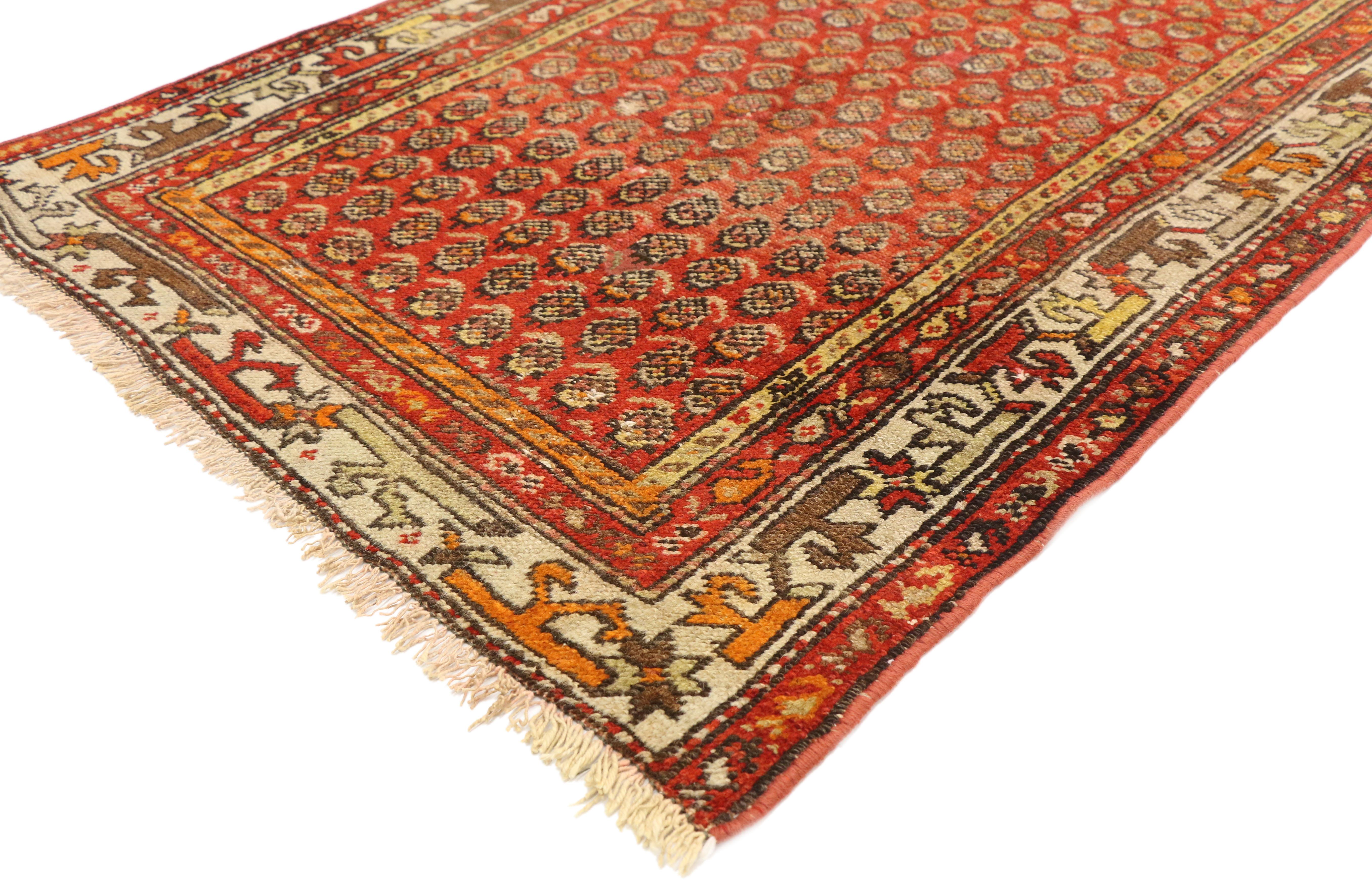 71448, antique Persian Boteh Hamadan accent rug with Tudor house manor style. This hand knotted wool antique Persian Boteh Hamadan rug is vibrant hued with a Classic Boteh pattern throughout an abrashed vermilion backdrop. It is framed by a series