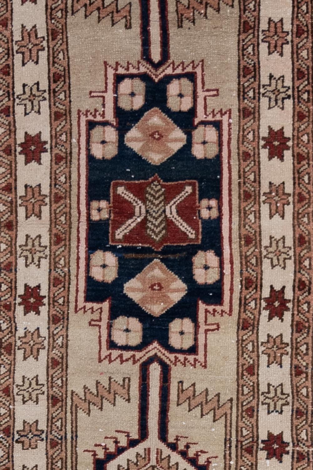 Age: early 20th century

Colors: pale camel, oxblood, navy blue, faded salmon

Pile: medium 

Wear Notes: 2

Material: wool on wool

Gorgeous antique camel field runner with a soft wool pile and earthy accent colors. This piece adds a