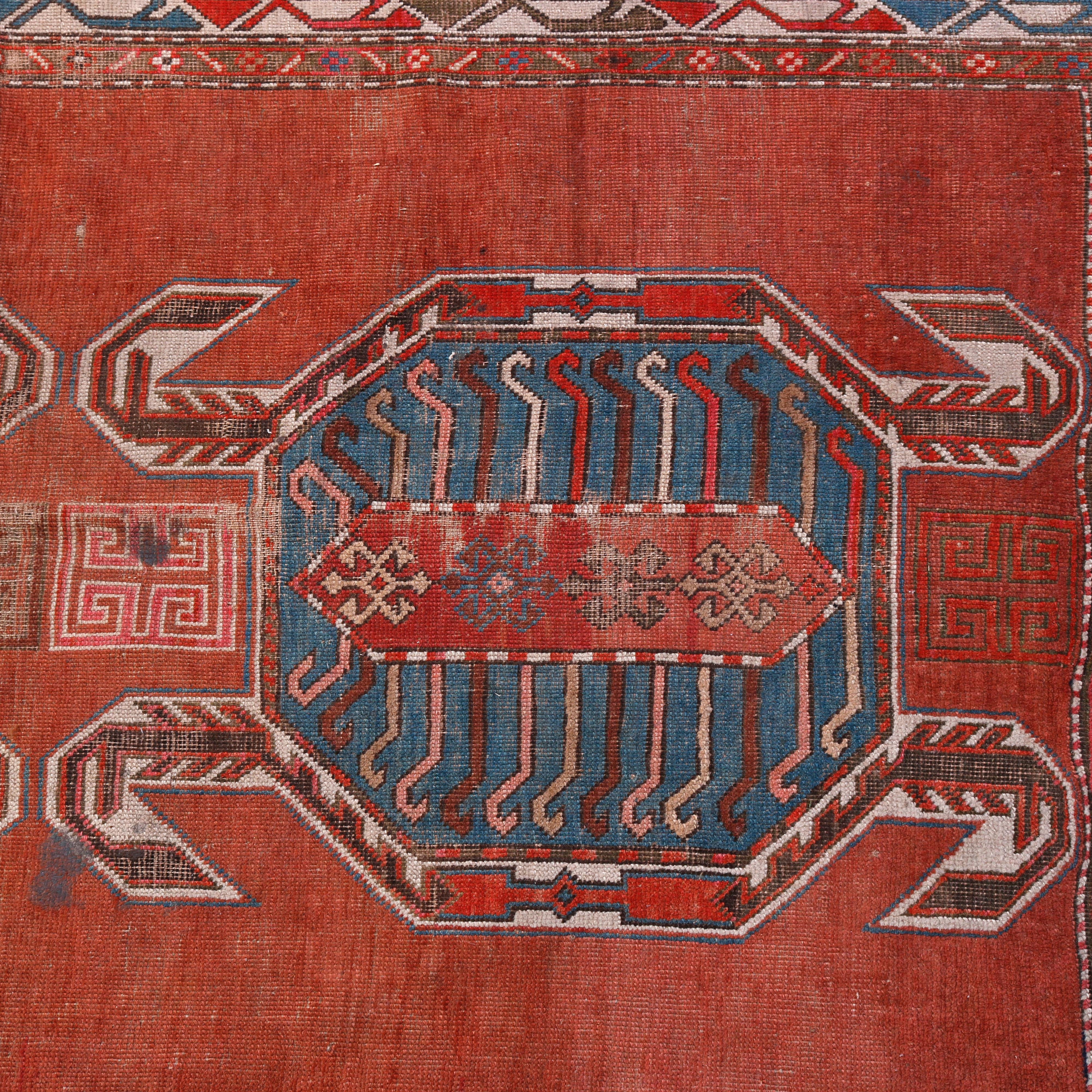 An antique figural Caucasian Lenkoran oriental rug offers wool construction with central facing stylized turtles on red ground, circa 1900.

Measures: 77