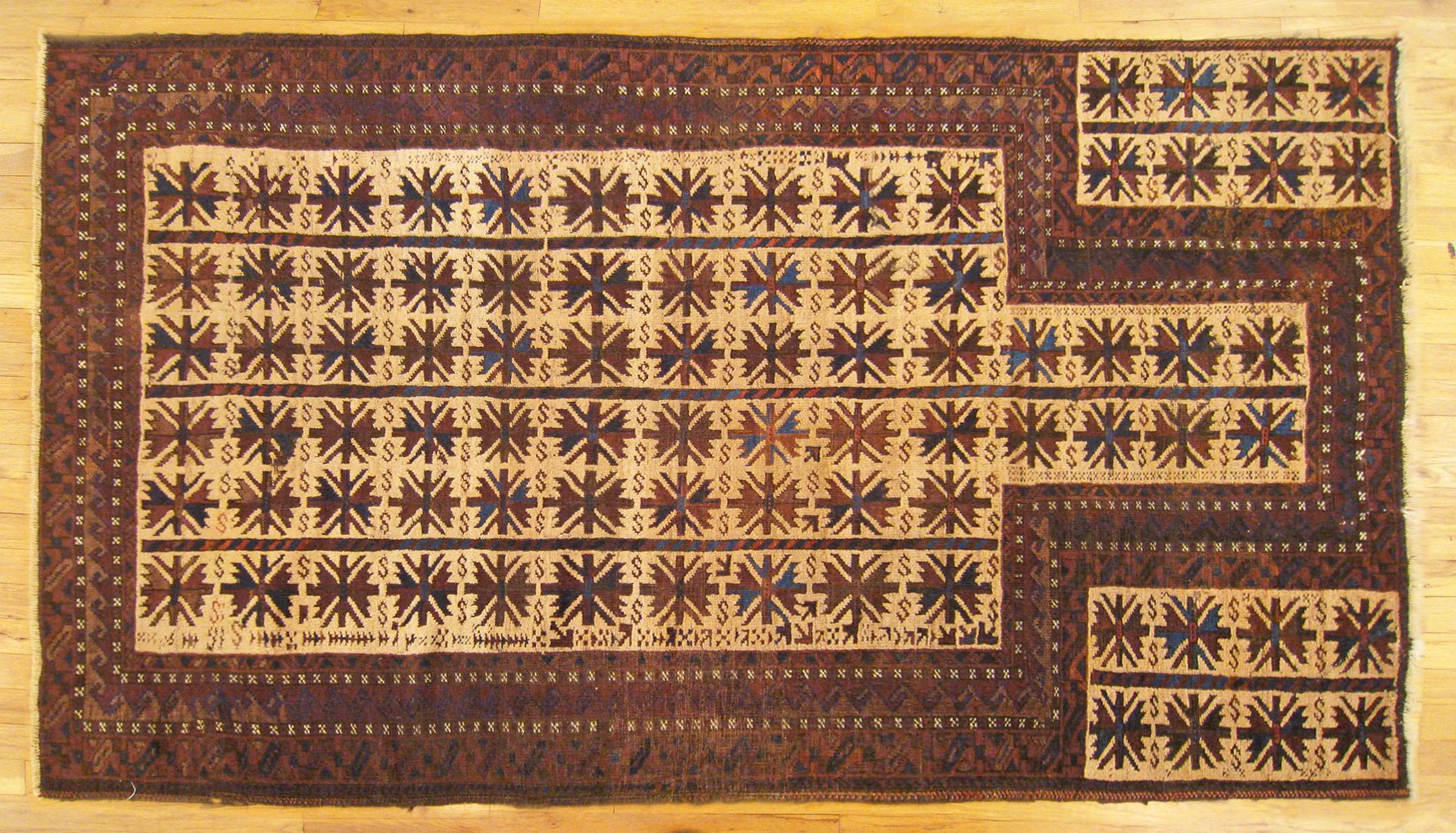 Antique Persian Belouch rug, Small size, circa 1920

A one-of-a-kind antique Persian Belouch Oriental Carpet, hand-knotted. This small rug features a prayer design in a directional position on an ivory central field. This field is enclosed within