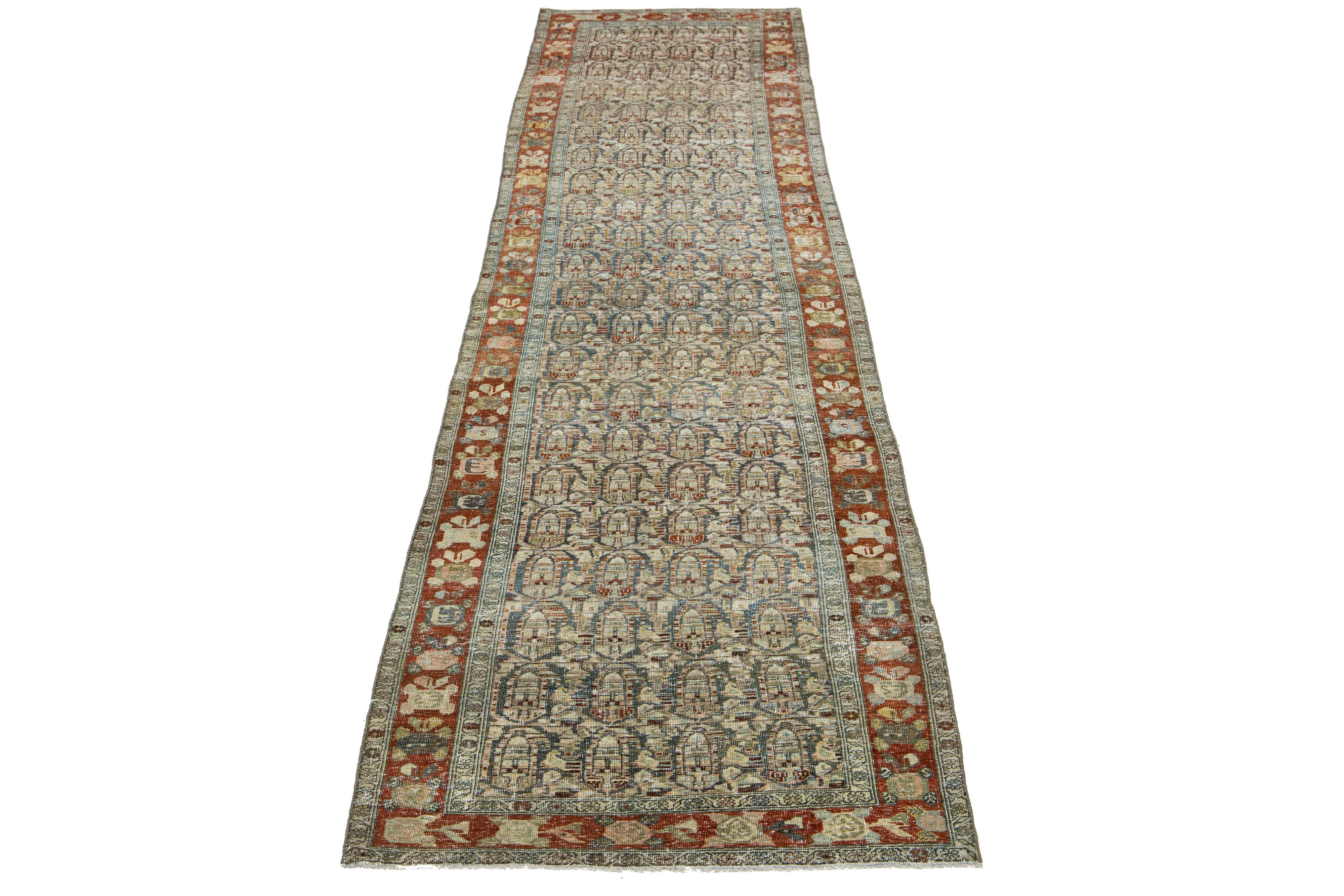 This Persian Malayer wool rug has an antique charm. It features hand-knotted wool in a blue field and an allover pattern adorned with rust, peach, beige, and brown accents.

This rug measures 3'4