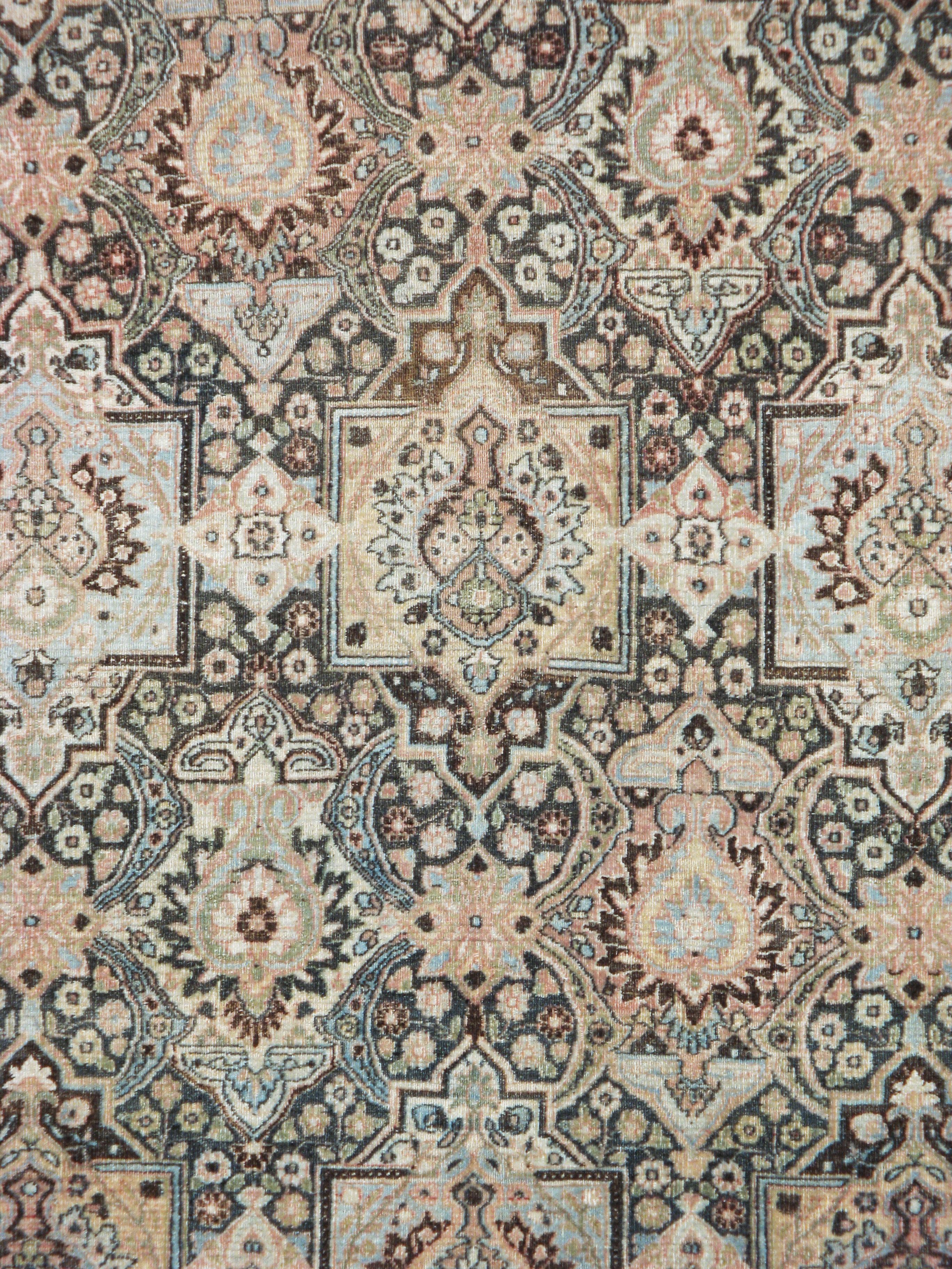 An antique Persian Dorokhsh carpet from the early 20th century. The dark brown field features squared cartouches enclosing palmettes alternating with palmettes-in-lozenges in offset rows. The ivory main border displays fan palmettes and other