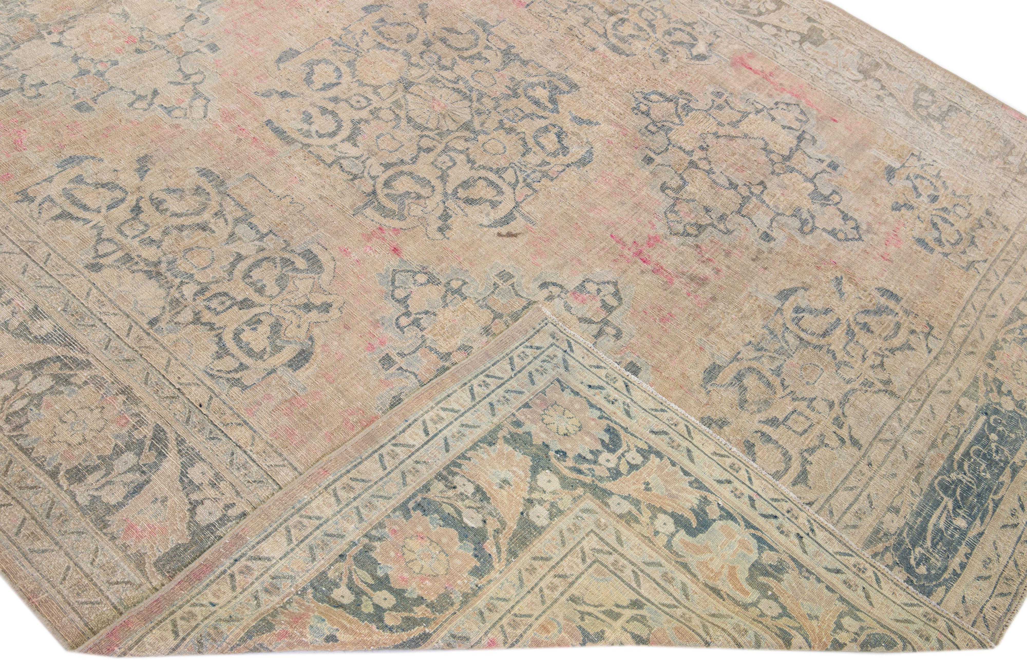 Beautiful antique Doroksh hand-knotted wool rug with a beige color field. This Persian rug has blue and pink accents in an allover floral pattern. 

This rug measures 7'8