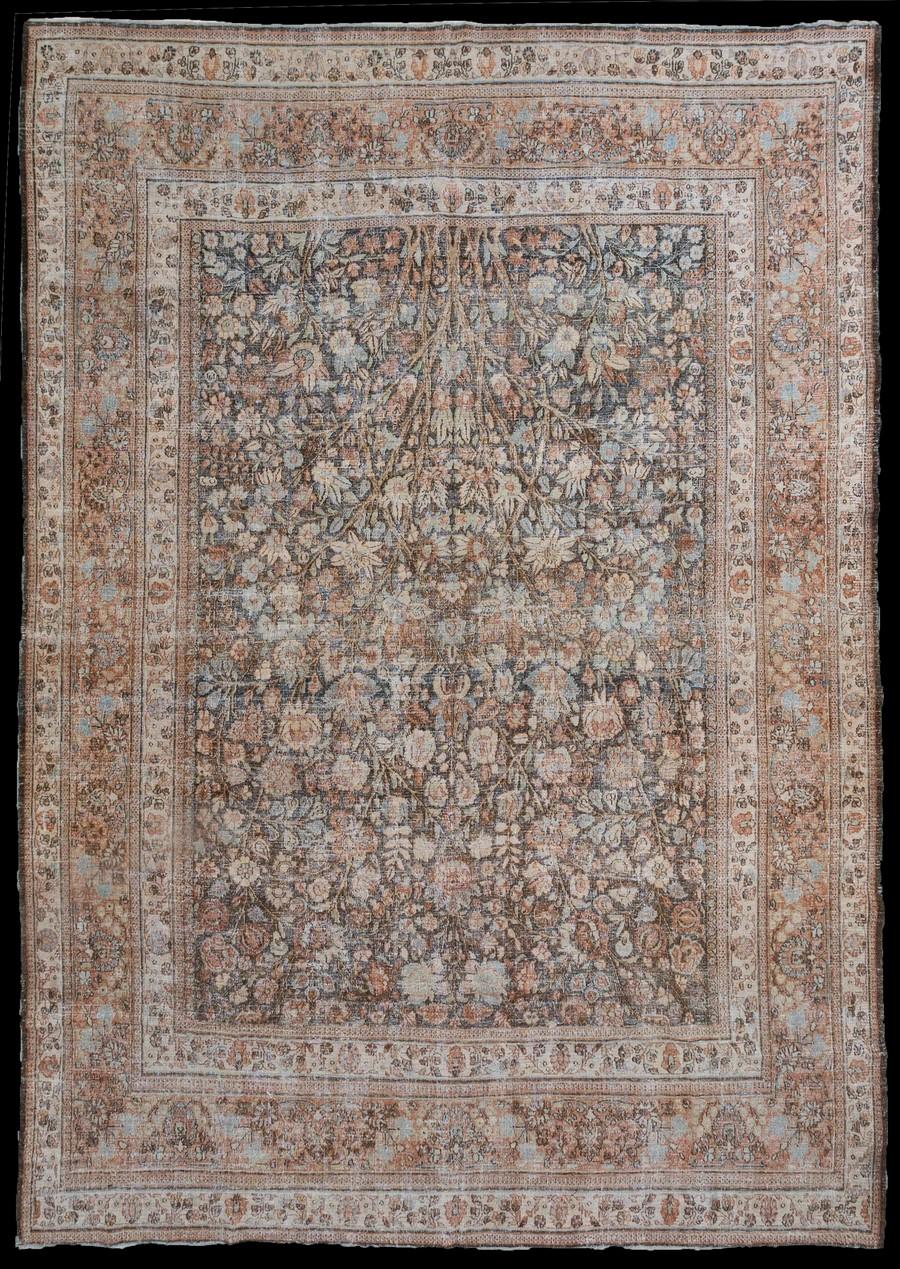 An early 20th Century Persian Doroksh Rug.
A true show stopper of a rug, this antique Persian Doroksh contains an intricately woven bouquet of flowers that is edgy and masculine (quite the interesting juxtaposition!). The moody colorway lends