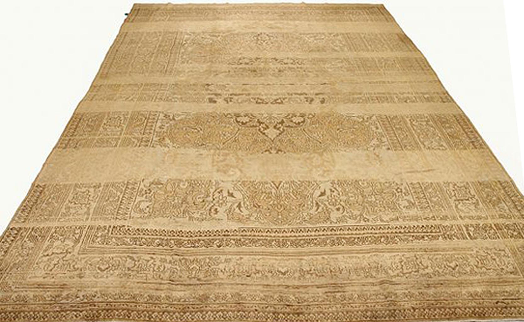 Antique Persian rug handwoven from the finest sheep’s wool and colored with all-natural vegetable dyes that are safe for humans and pets. It’s a traditional Doroksh design featuring floral details in brown and beige over an ivory field. It’s a